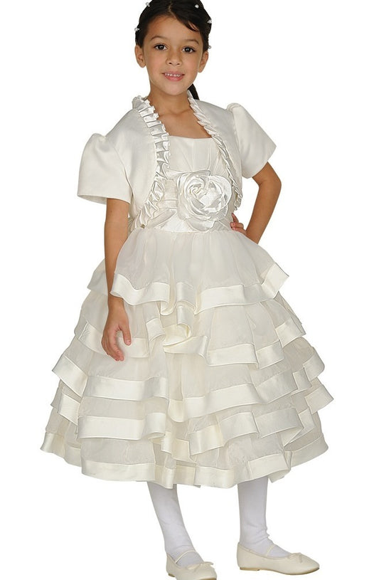 Young girl wearing an ivory satin dress with ruffles and a rose 