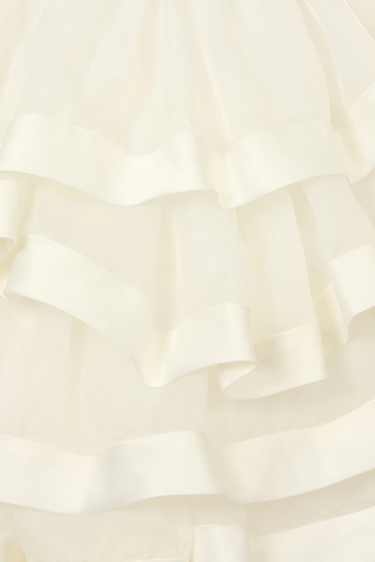 Finished details of a large flower at the waist distinguish the Ivory kids party dress.