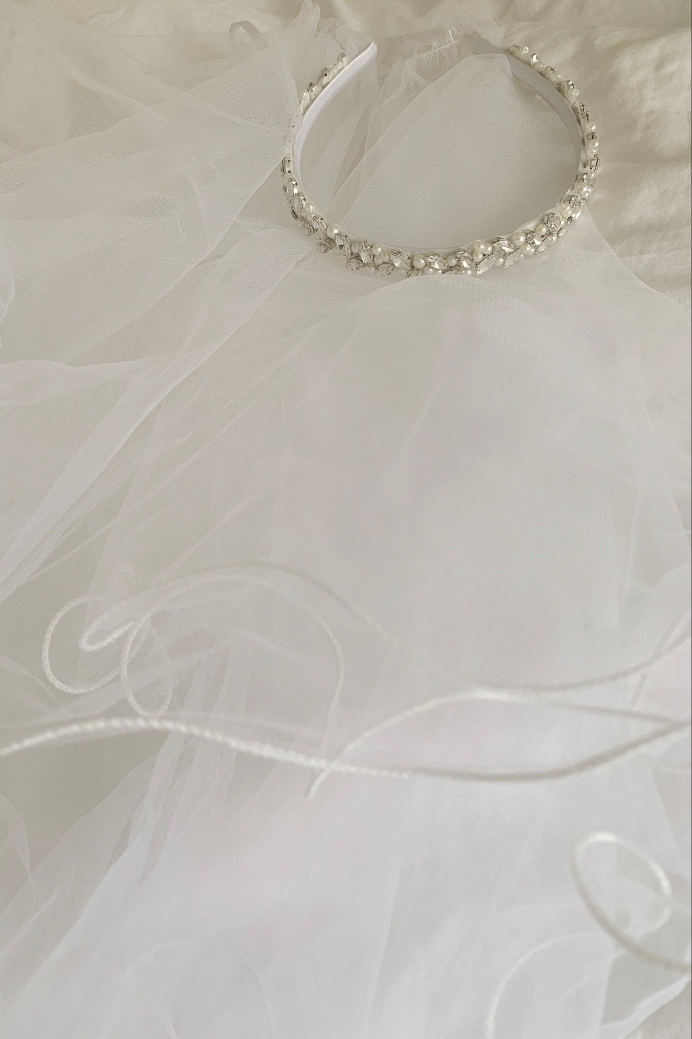 White pearl rhinestone flower girl and first communion headband and two-tier veil.