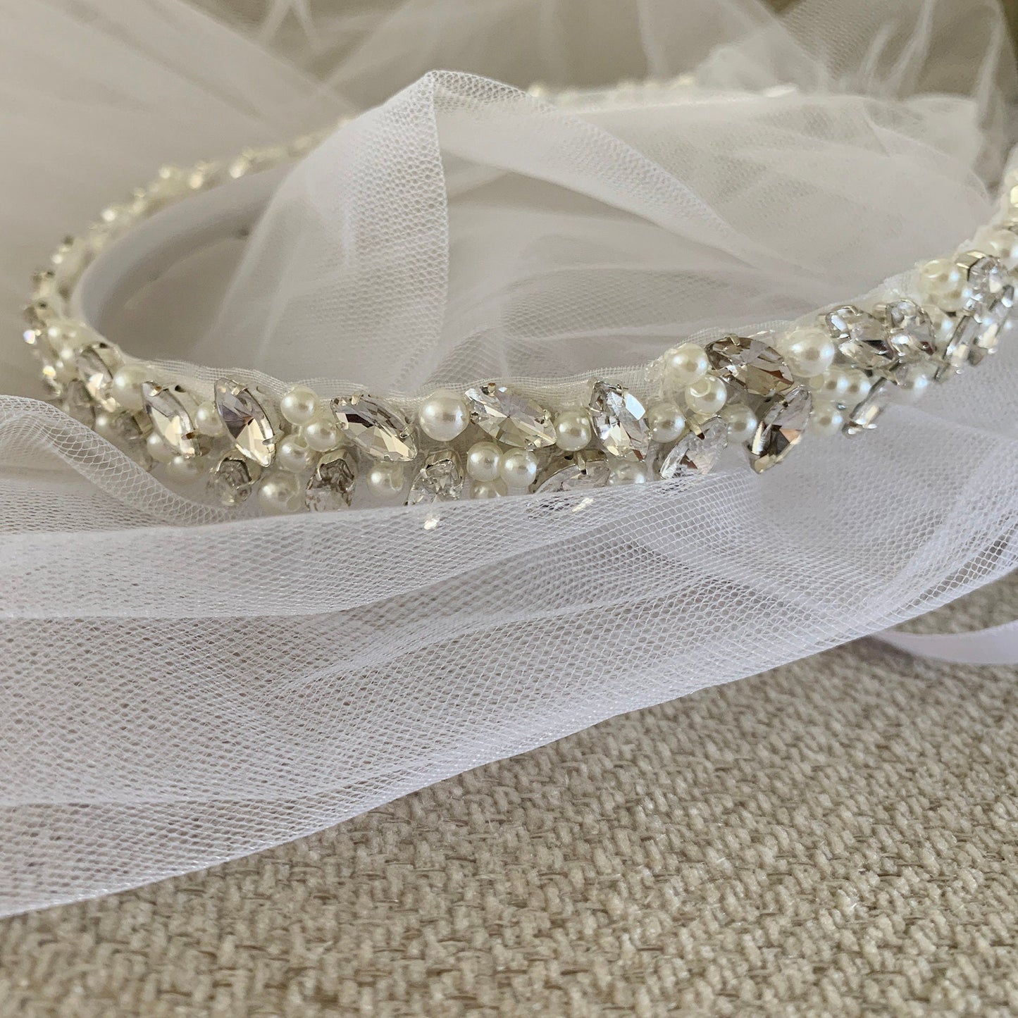 White pearl rhinestone tulle flower girl and first communion headband and two-tier veil.