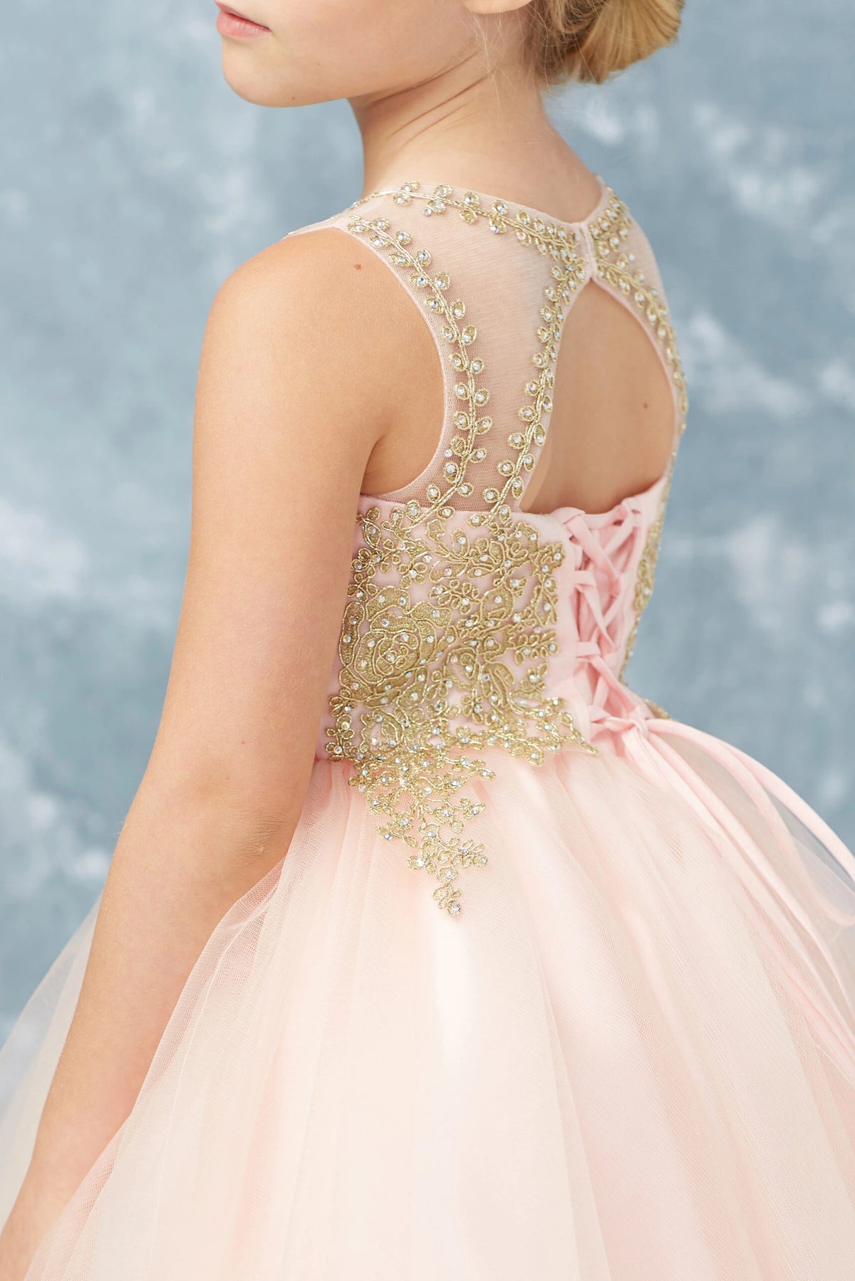 Another view of the Blush kids pageant dress shows metallic lace framing the upper back.