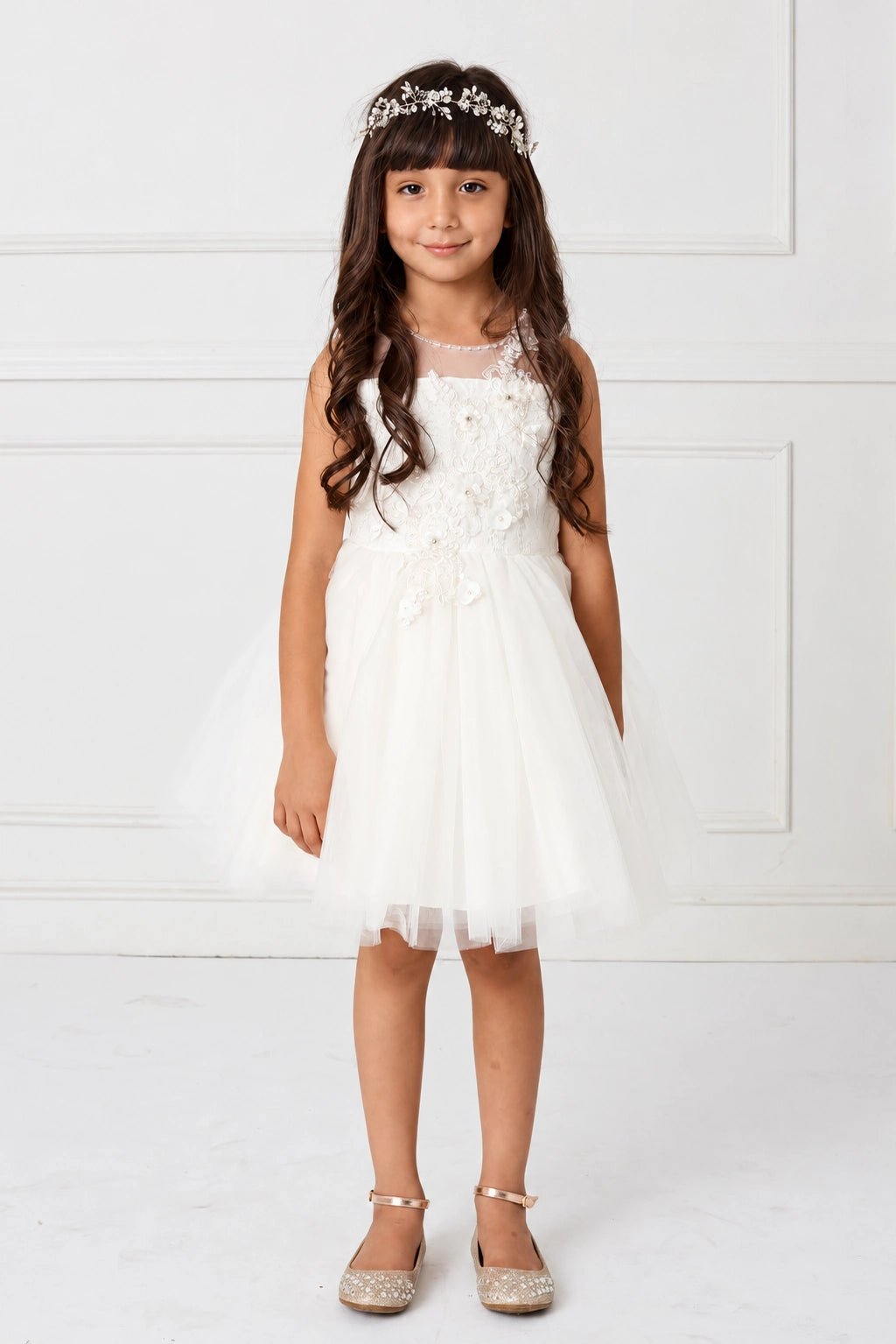 Shown here, an off-white flower girl dress with an asymmetric flower bodice.