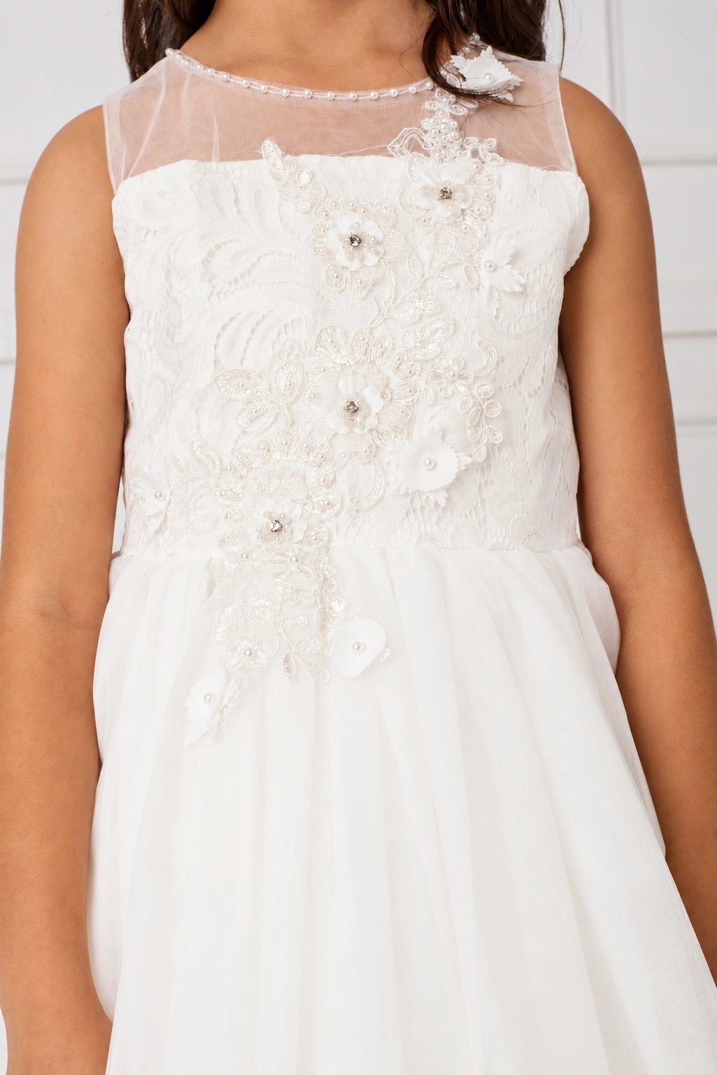 With a 3D floral bodice, an off-white flower girl dress.