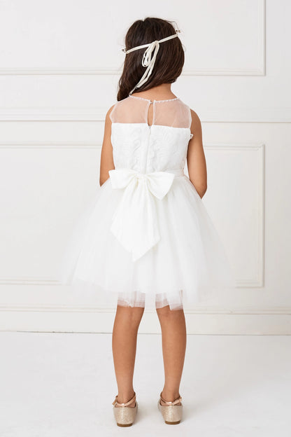 Detailed with a large satin back bow, this white flower girl dress.