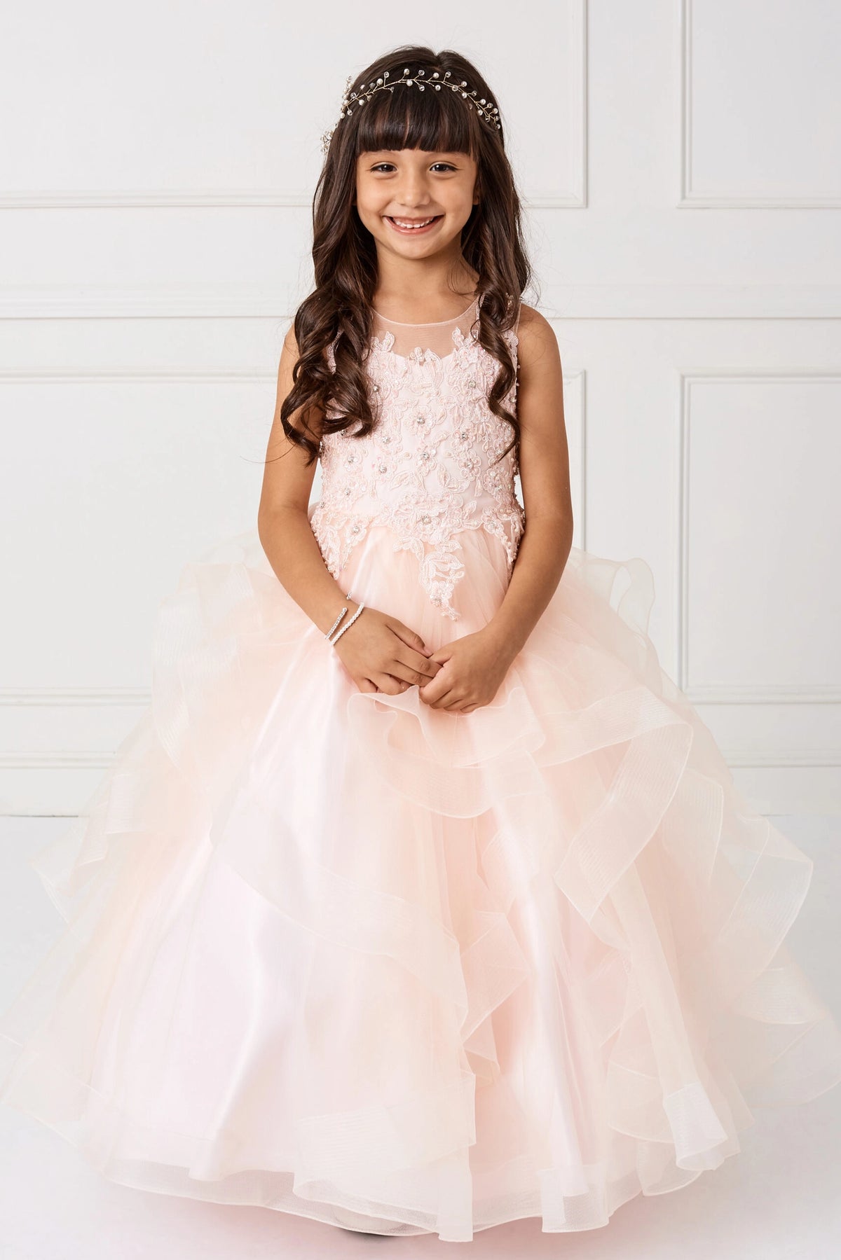 Blush kids pageant dress featuring a lace bodice and tiered mesh skirt.