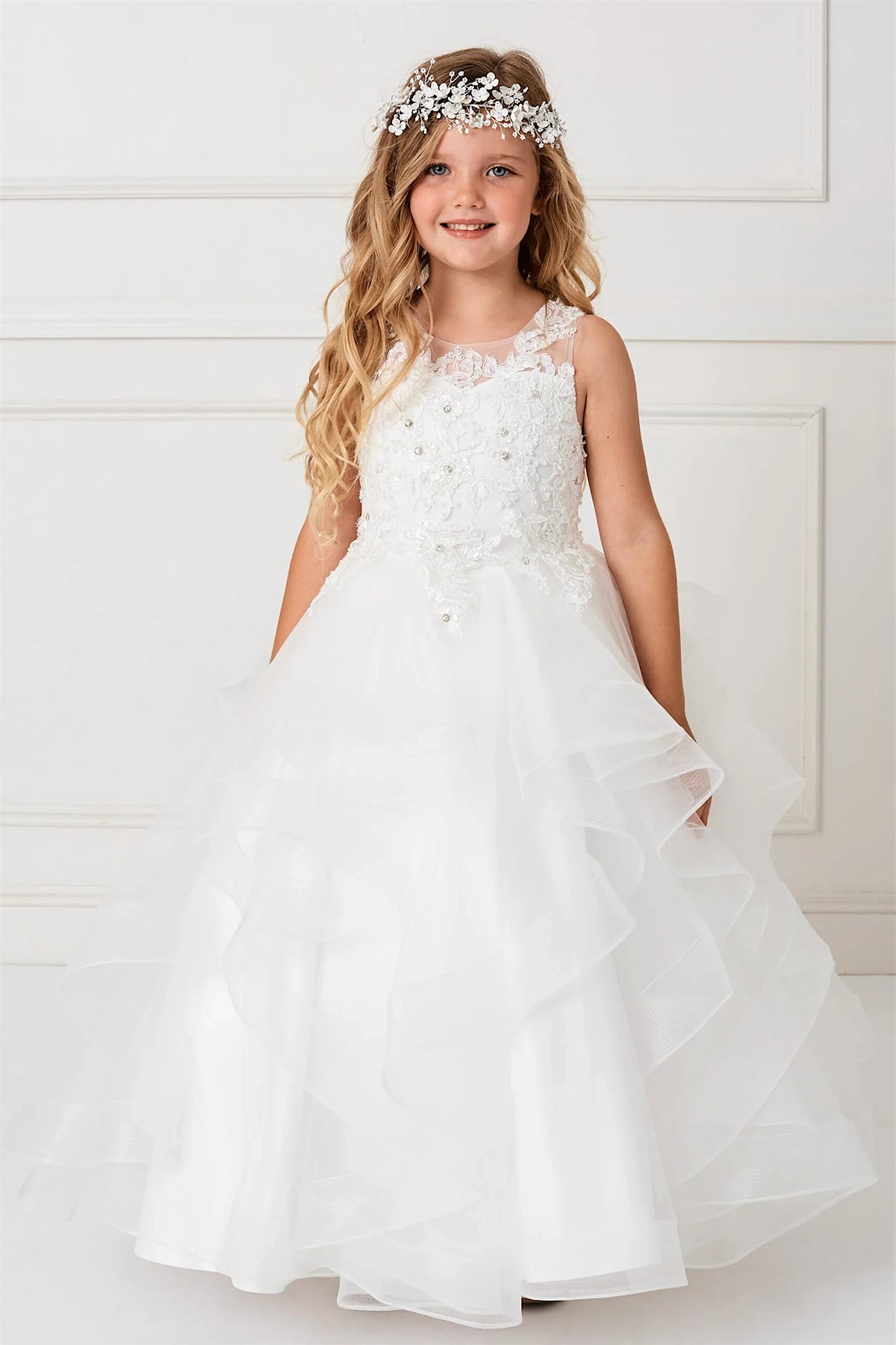 Cascading mesh tiers fall below the floral lace bodice of this ivory kids dress.