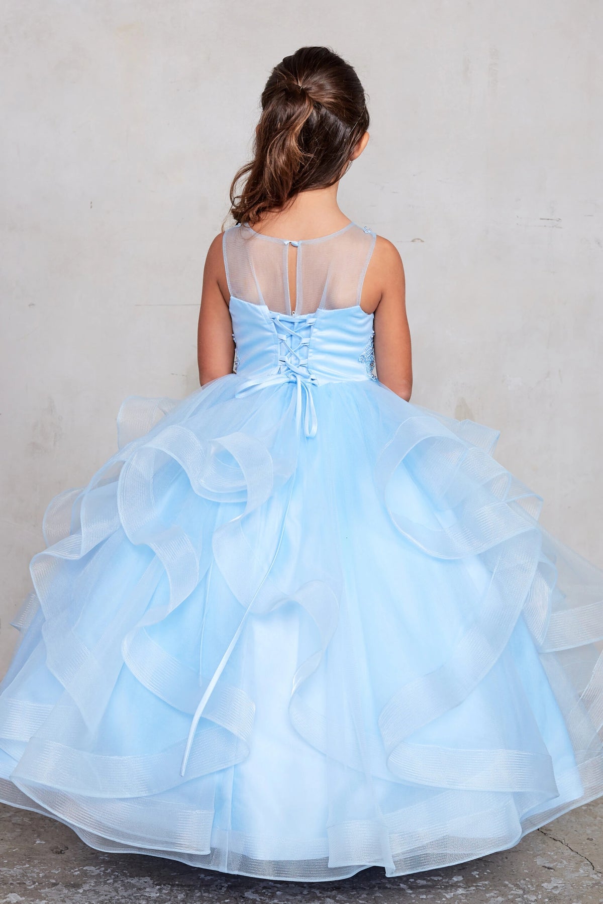 On the Sky Blue kids pageant dress, the detailing includes lace-up ties at the back.