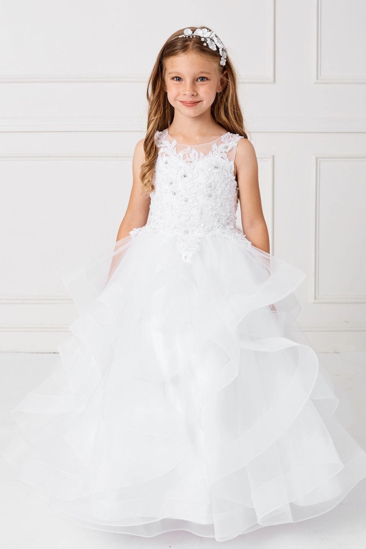 On the White kids pageant dress, the detailing includes a lace bodice and tiered mesh skirt.