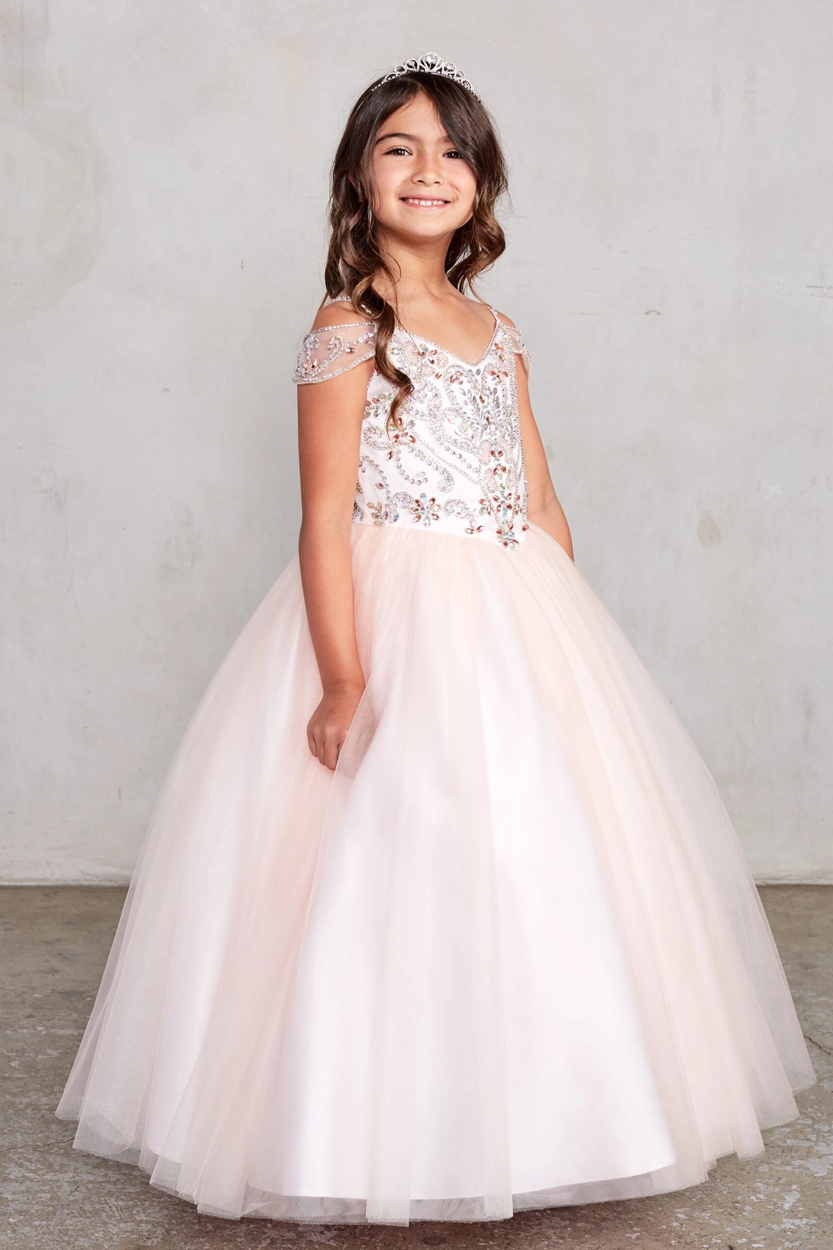 The Blush kids pageant dress has beaded detailing around a V-neckline.