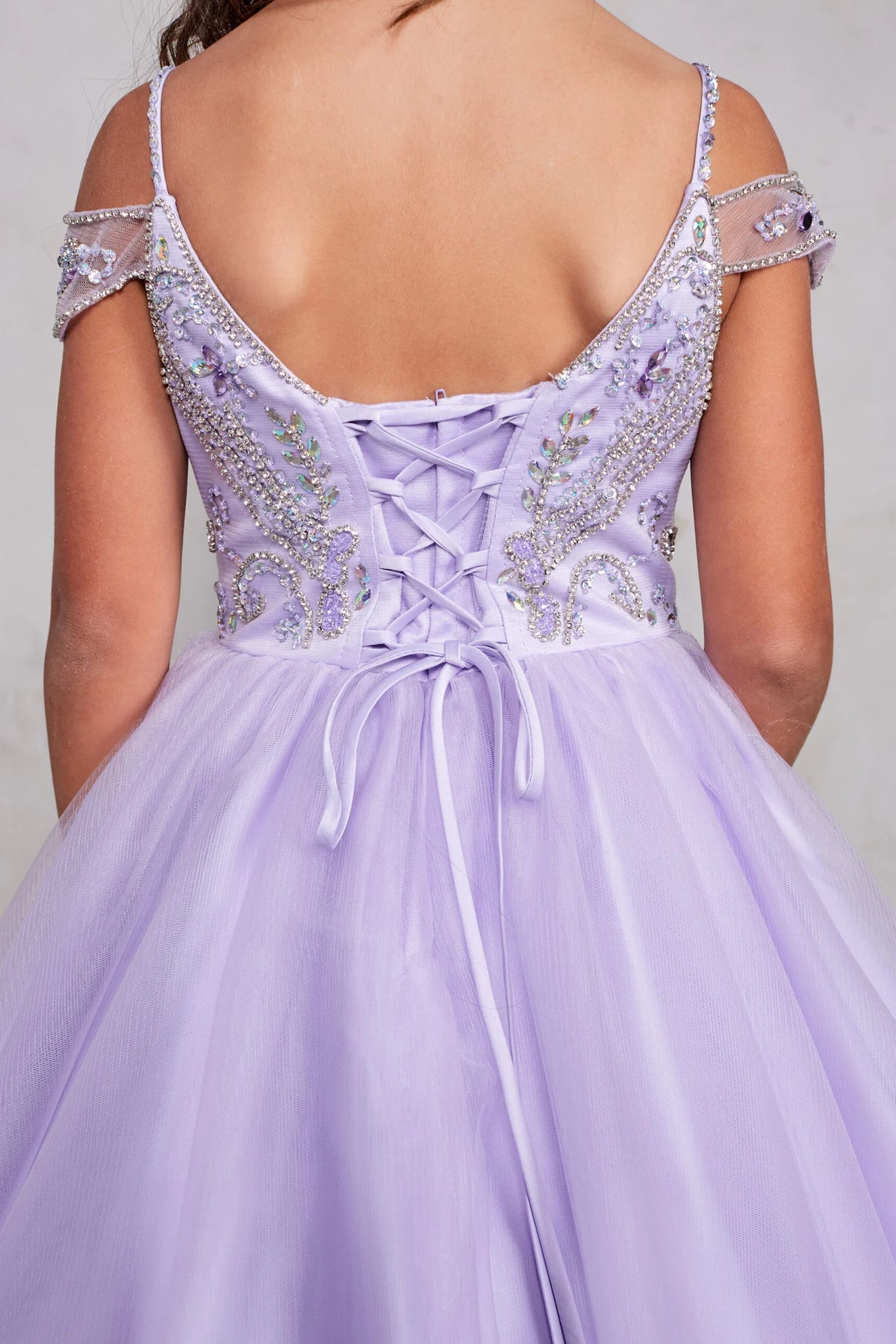 The Lilac kids pageant dress has beaded trim around the back opening.