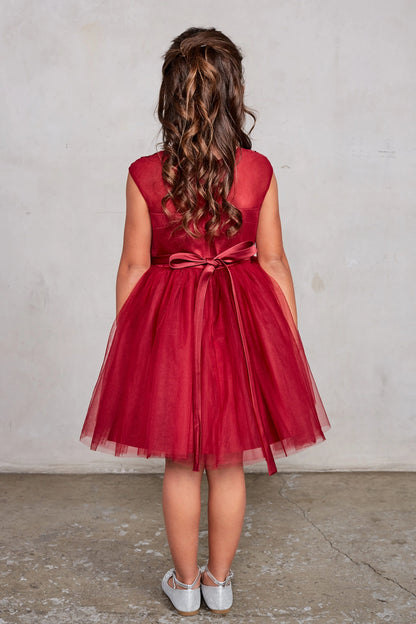 Seen from behind, this Burgundy kids pageant dress displays a tied sash across the back waist.