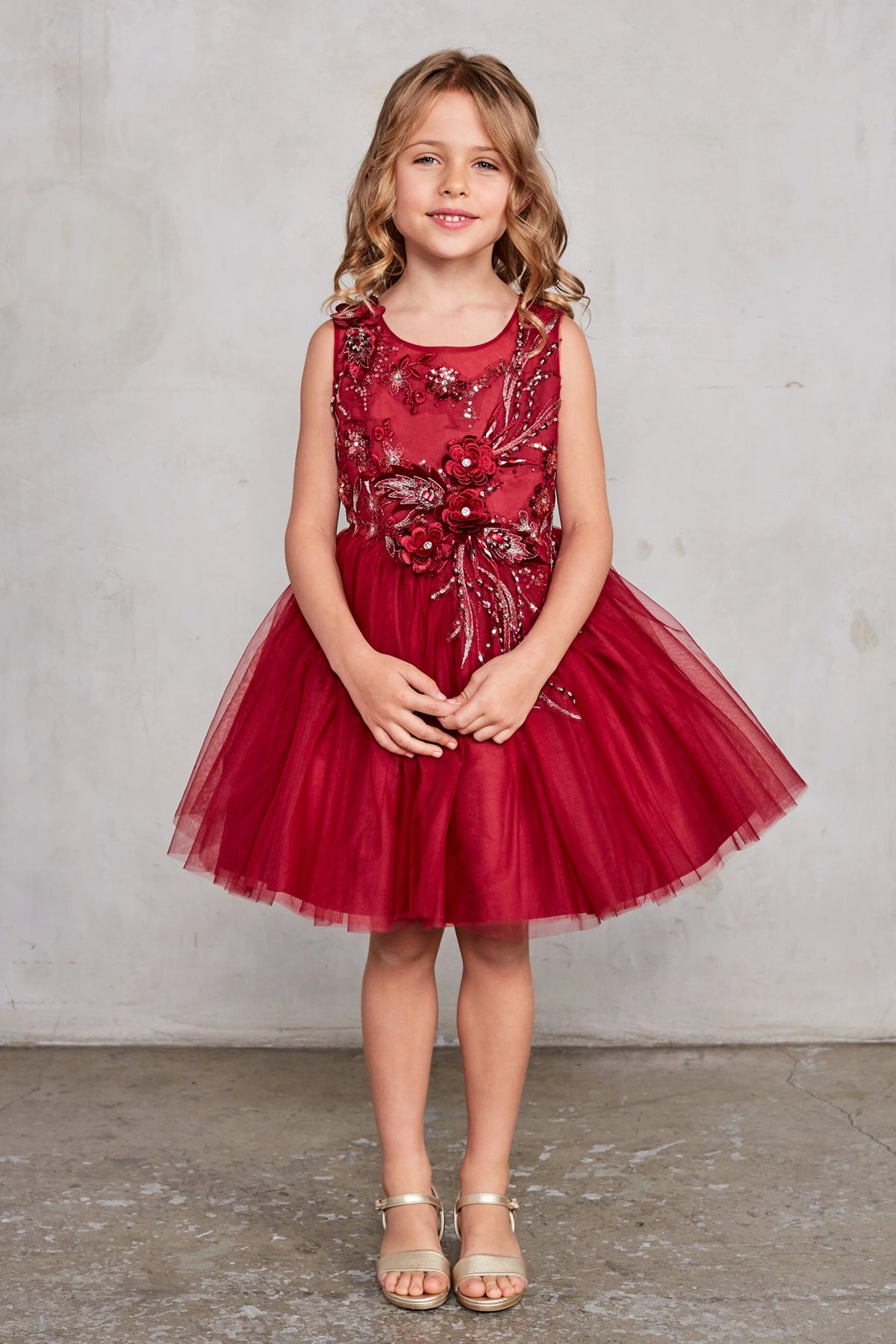 Visible details on the Burgundy kids pageant dress include dimensional floral embellishments.