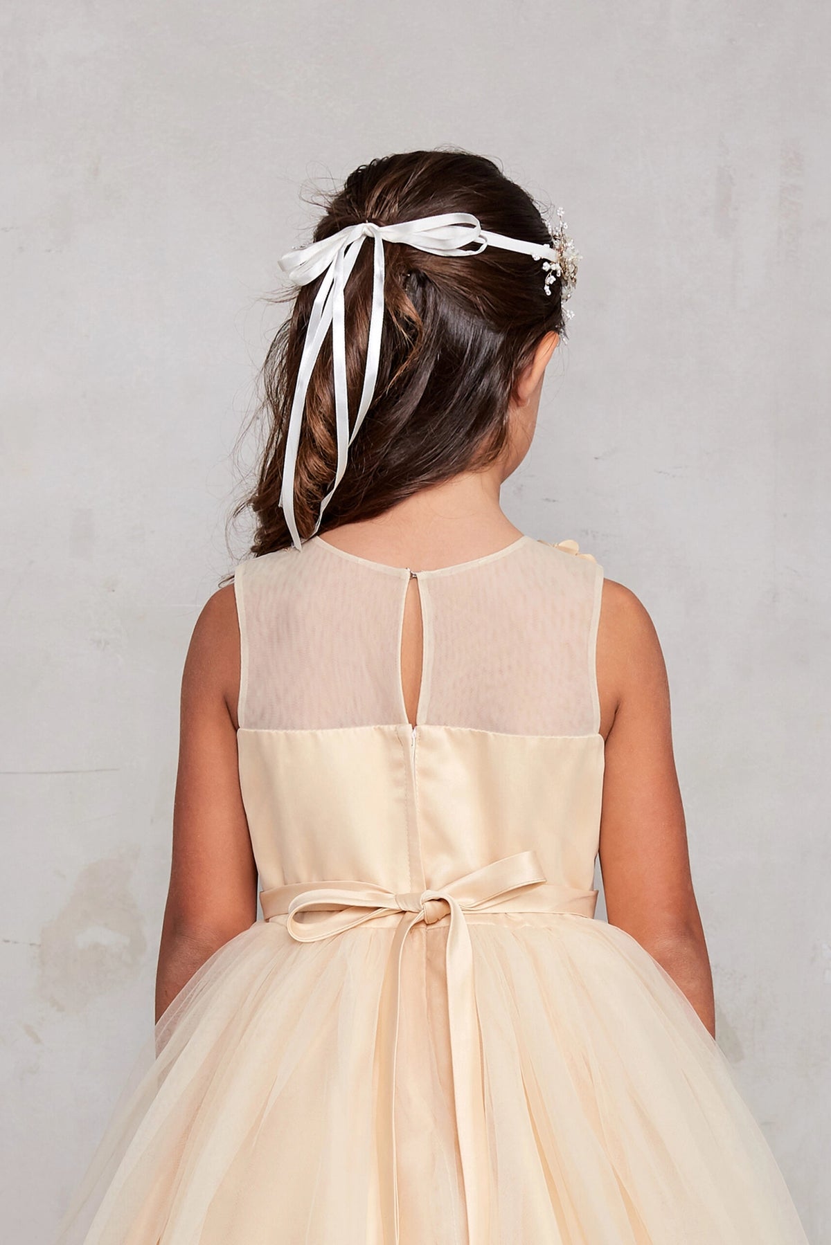 Visible details on the Gold kids pageant dress include a tied sash across the back waist.