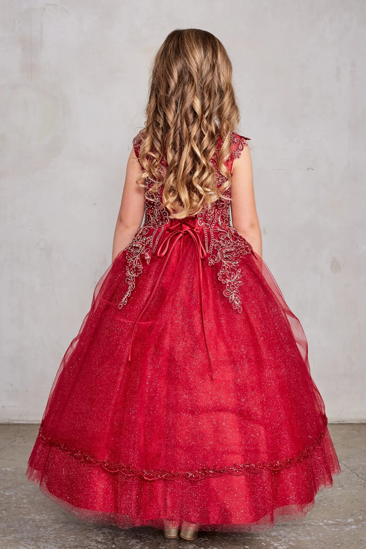 The Red kids pageant dress has a tied sash across the back waist.