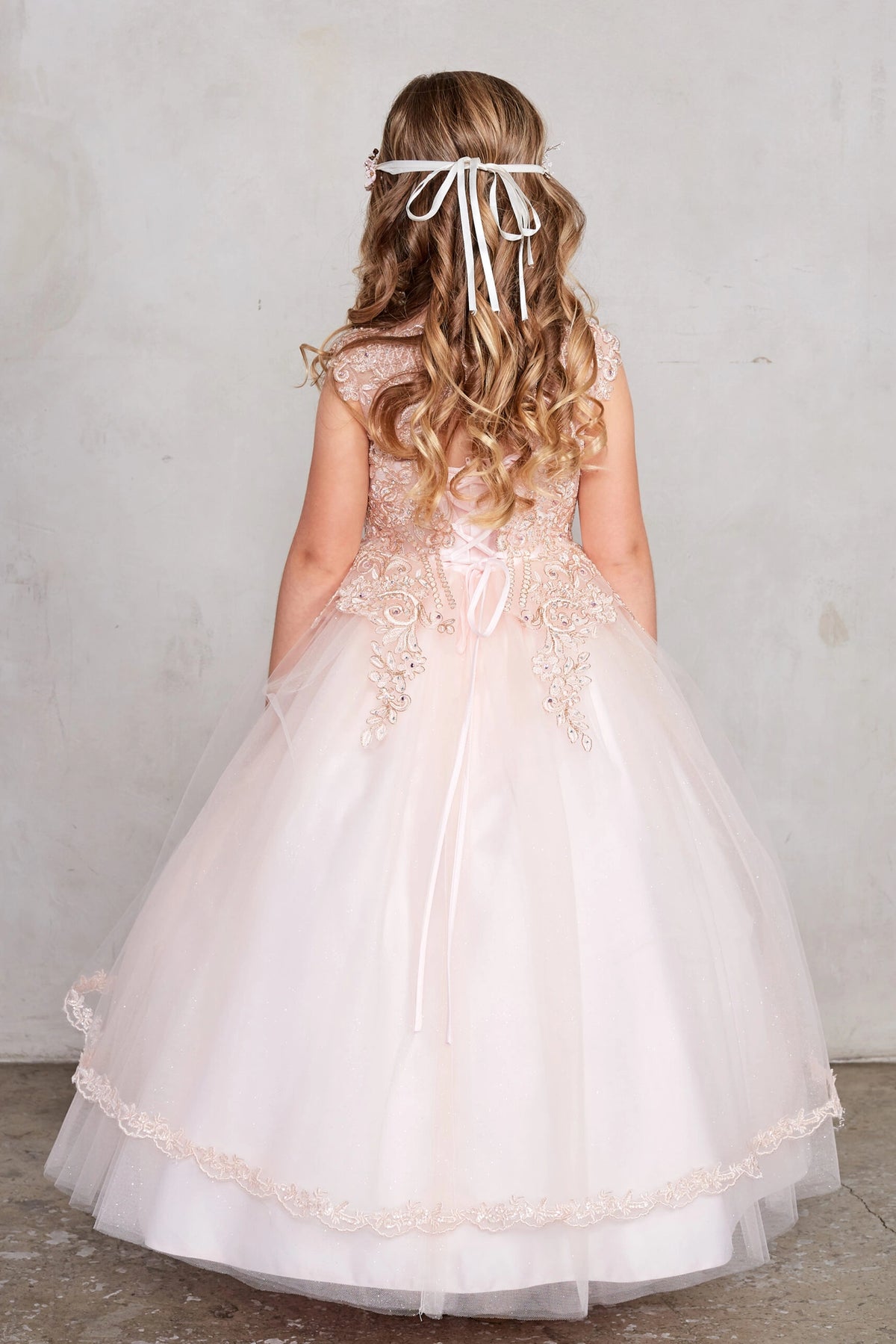 Visible details on the Rose Gold kids pageant dress include a tied sash across the back waist.
