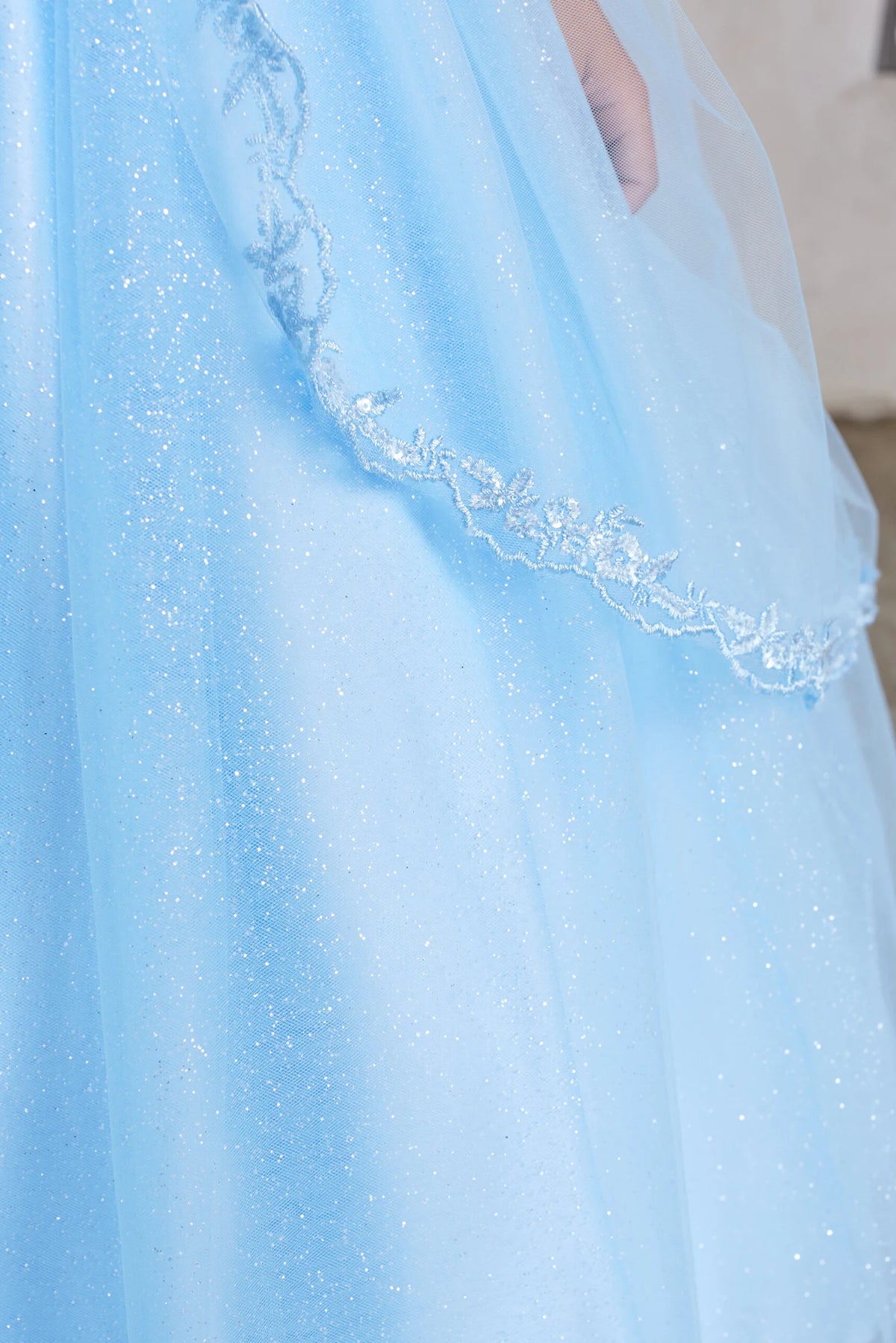 On the Sky Blue kids pageant dress, the detailing includes lace edging over glitter tulle.