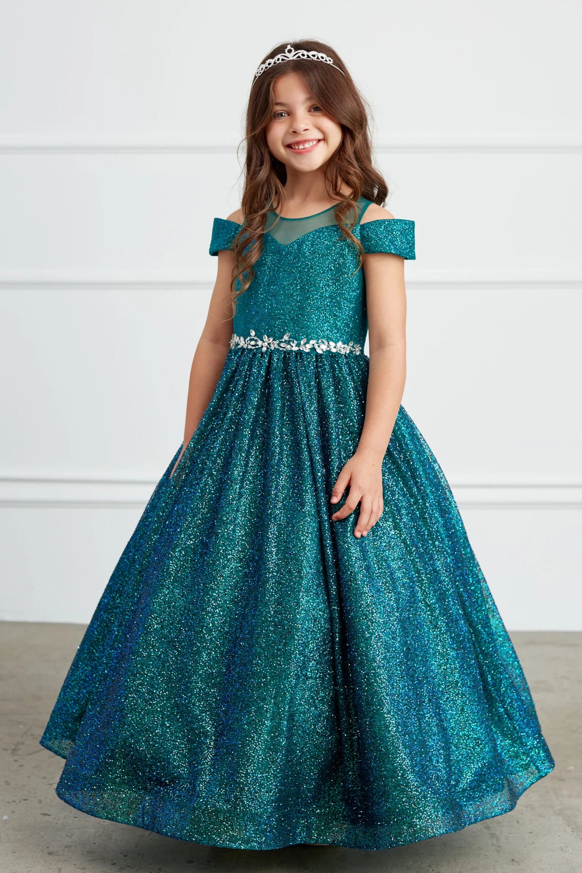 The Emerald kids pageant dress has a rhinestone waist and glitter skirt.