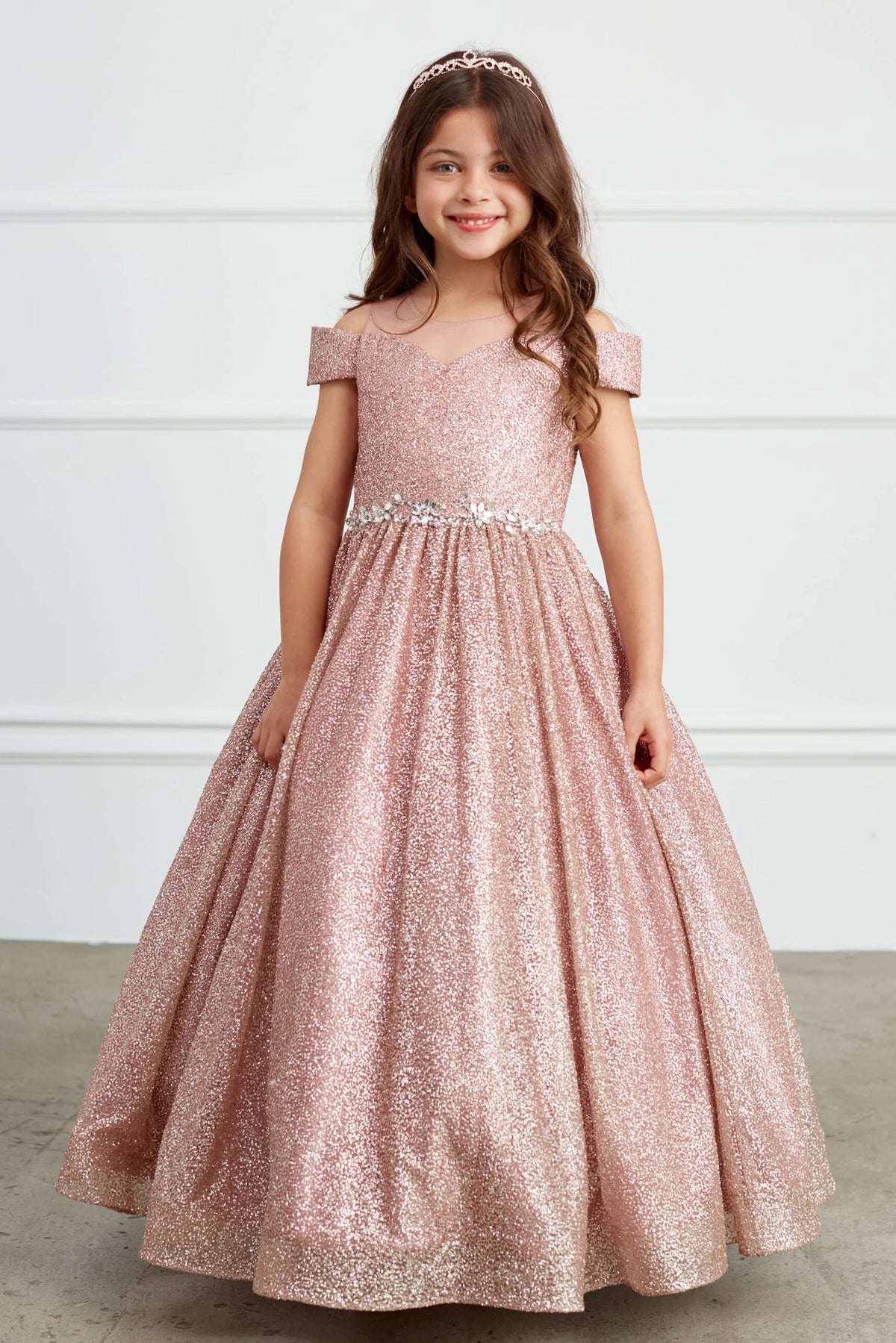 Visible details on the Rose Gold kids pageant dress include a rhinestone waist and glitter skirt.