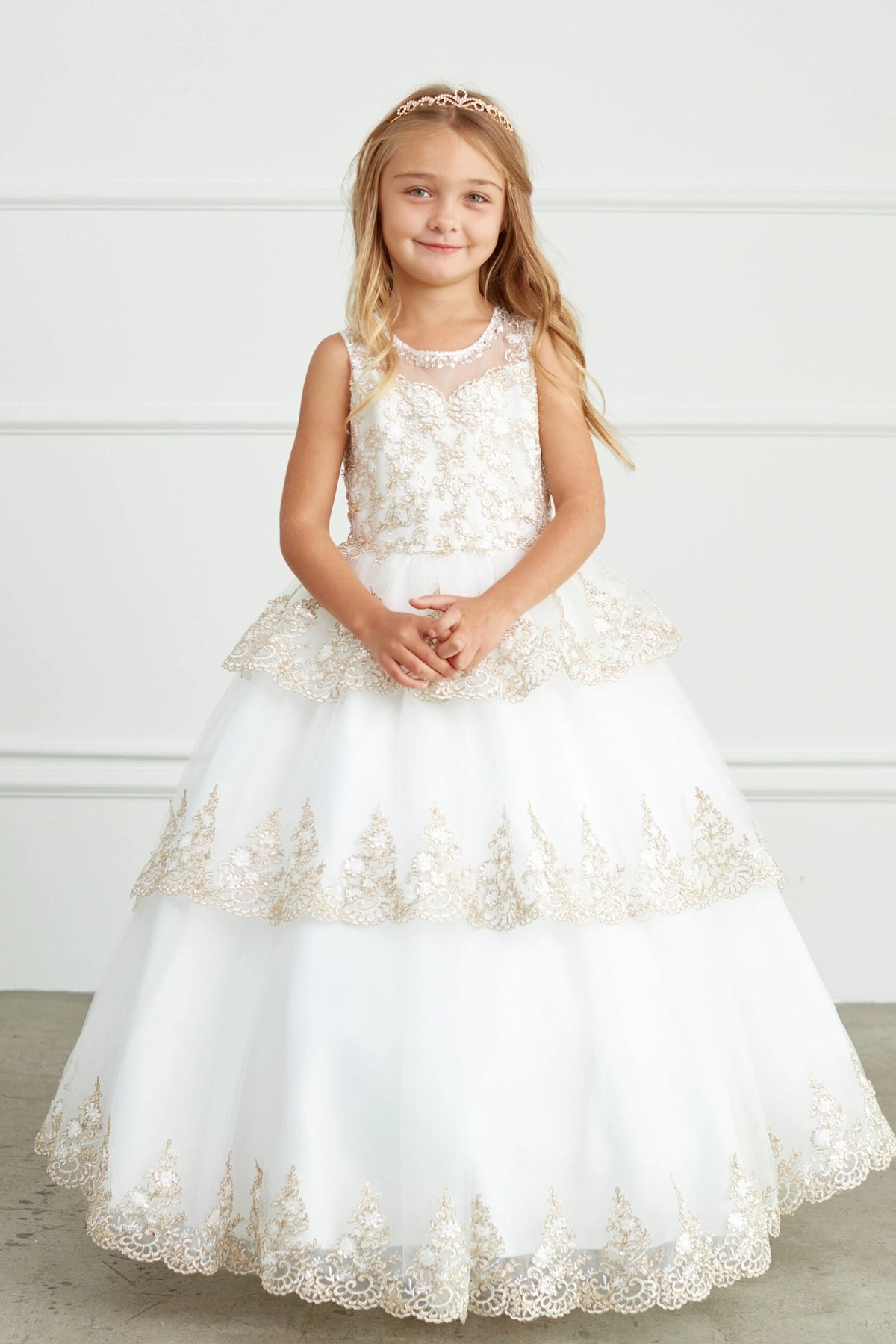 Ivory kids pageant dress featuring corded lace edging on layered tulle.