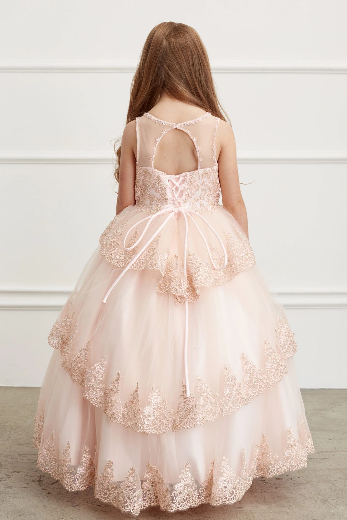 The Rose Gold kids pageant dress has lace-up ties at the back.
