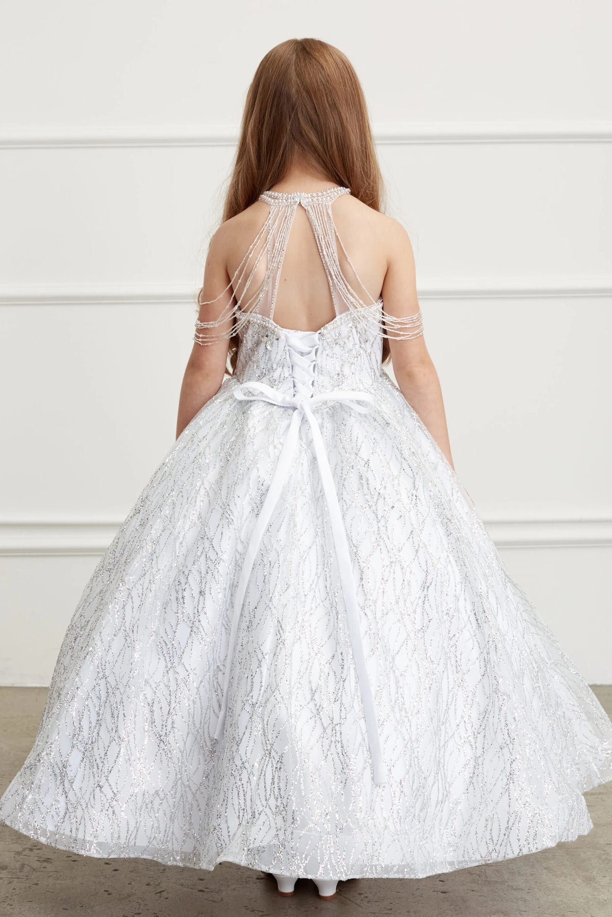 The White kids pageant dress has lace-up ties at the back.