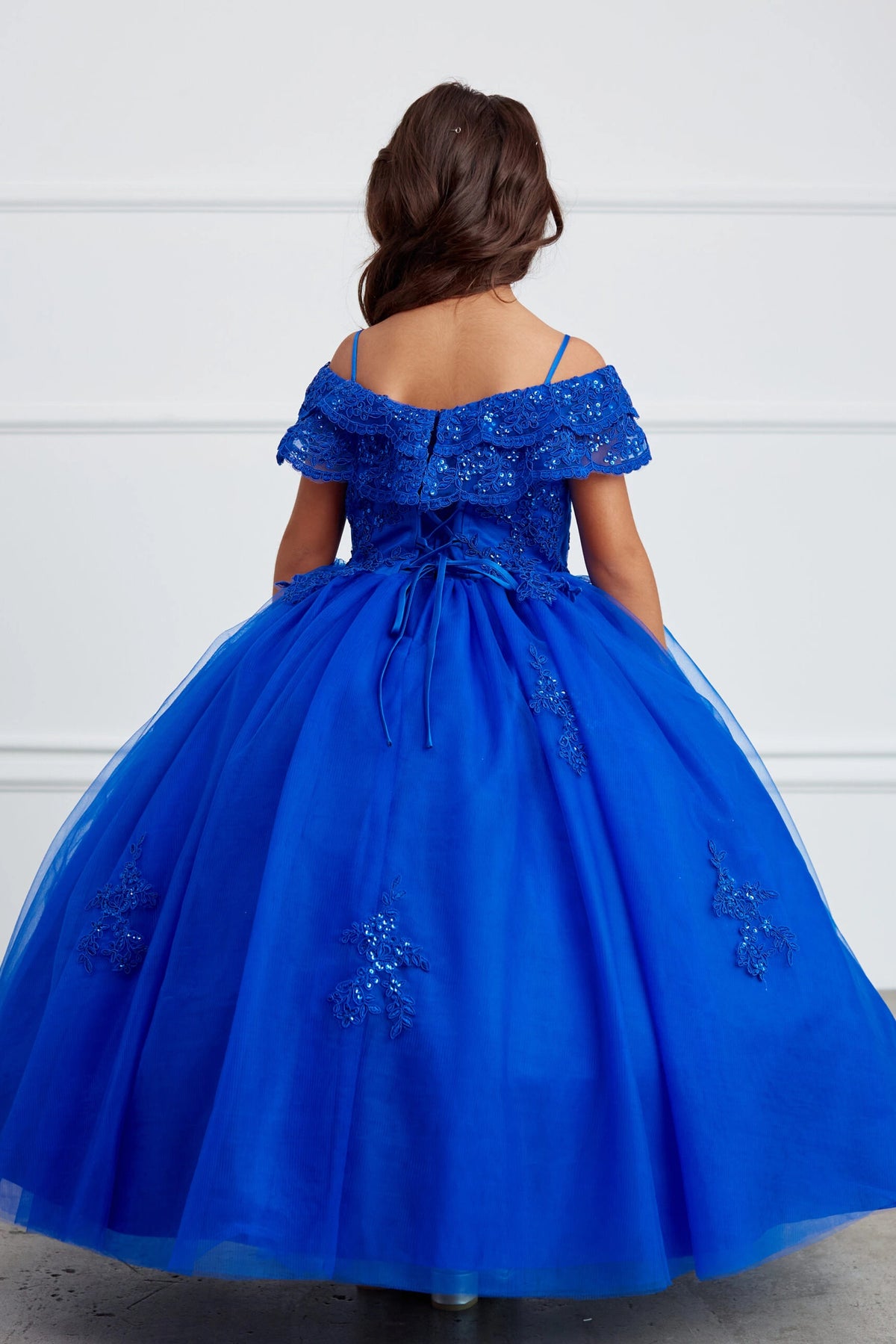 The Royal Blue kids pageant dress has lace-up ties at the back.