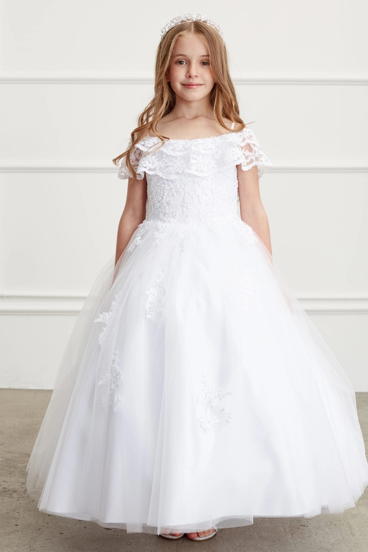 White kids pageant dress featuring a ruffled off-the-shoulder neckline.