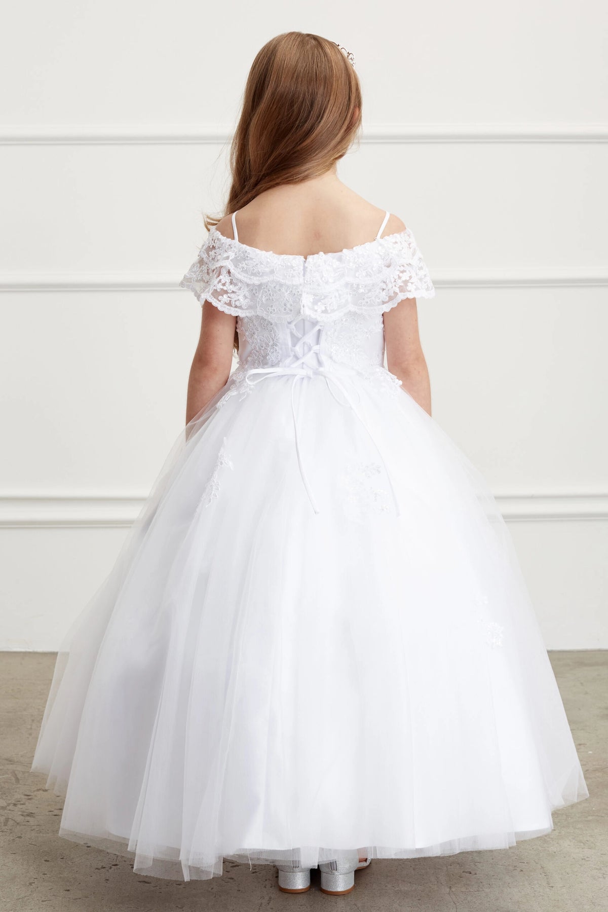 The White kids pageant dress has lace-up ties at the back.