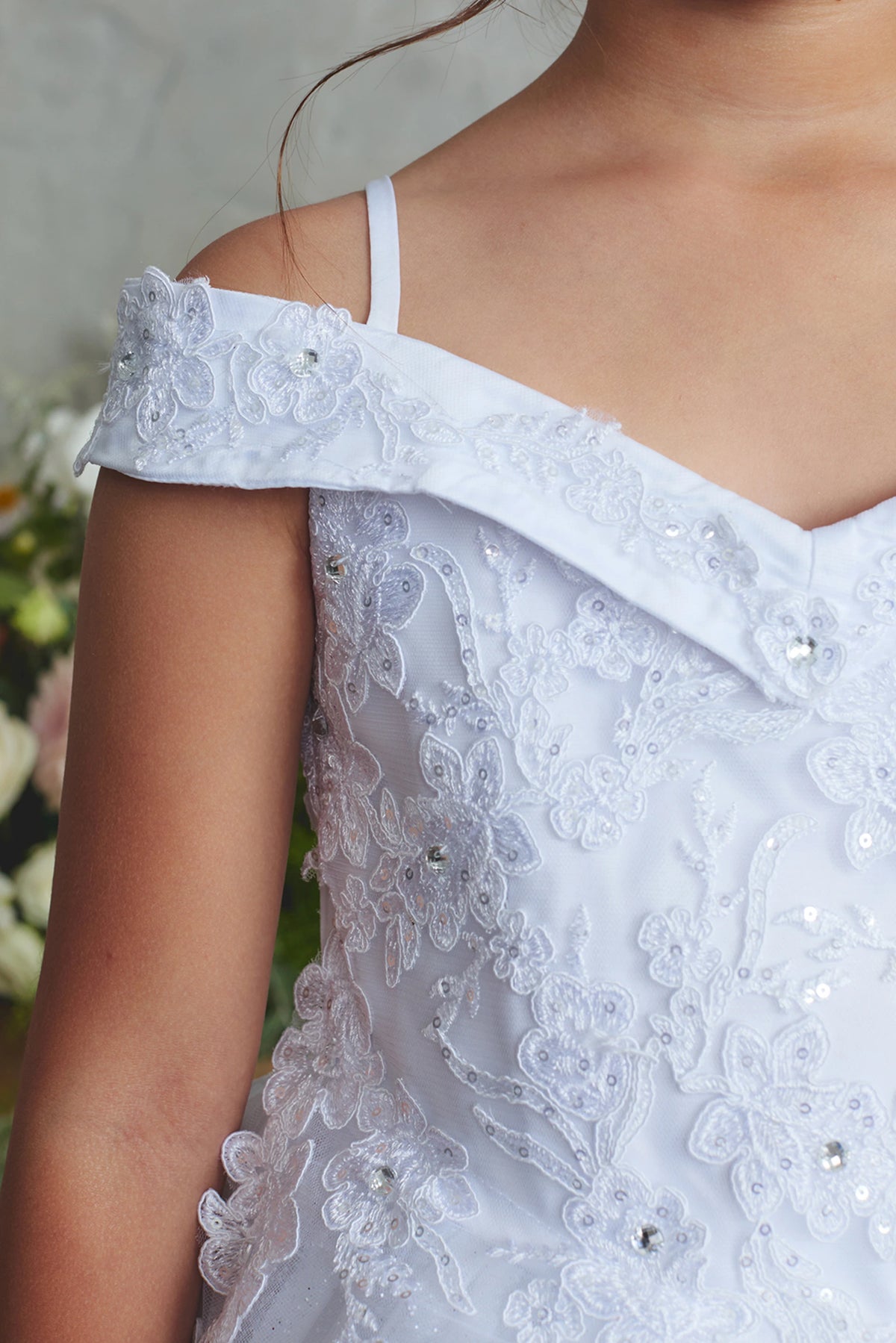 The White kids pageant dress has corded floral lace.