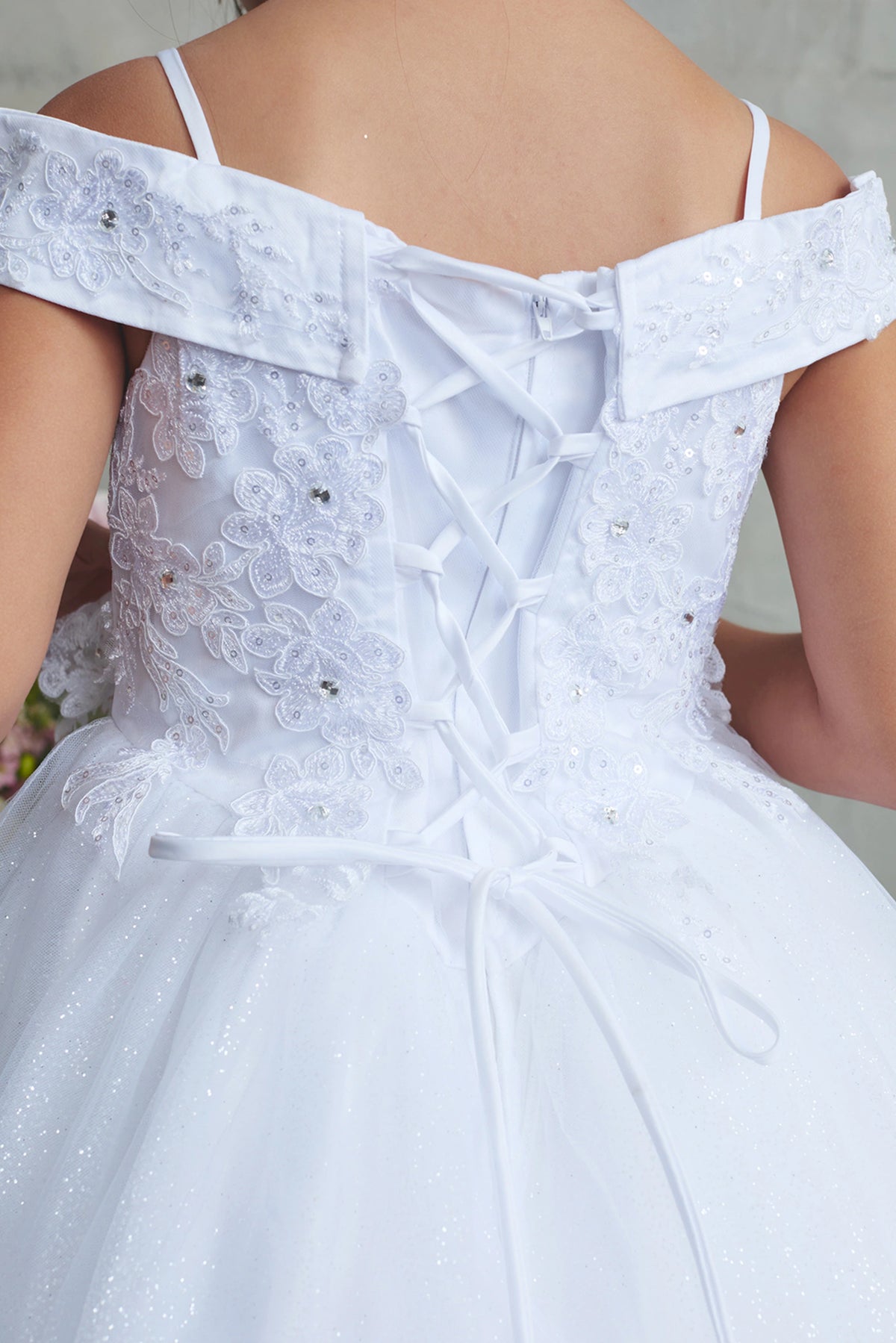 Showing corded floral lace, the White kids pageant dress has a detailed finish.