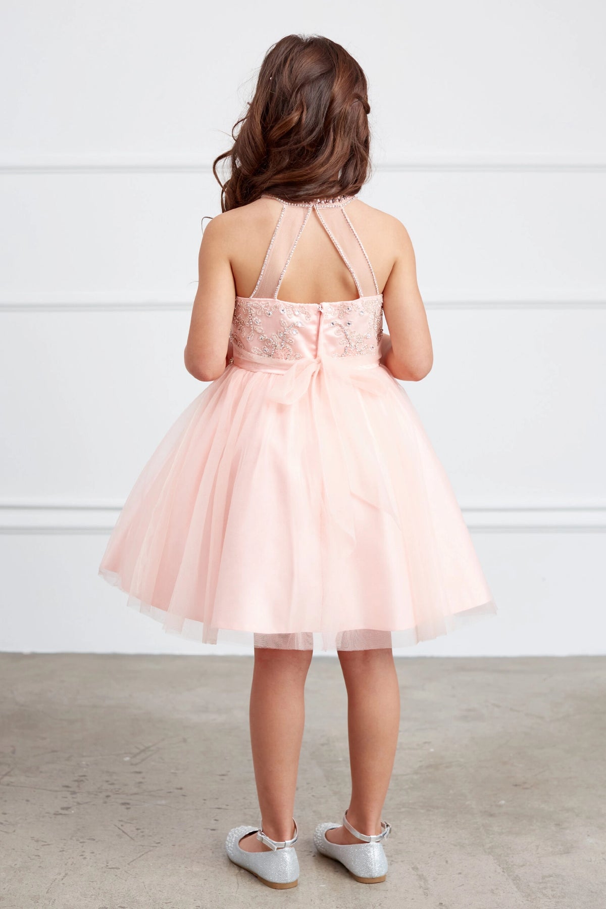 The Blush kids pageant dress has a tied sash across the back waist.