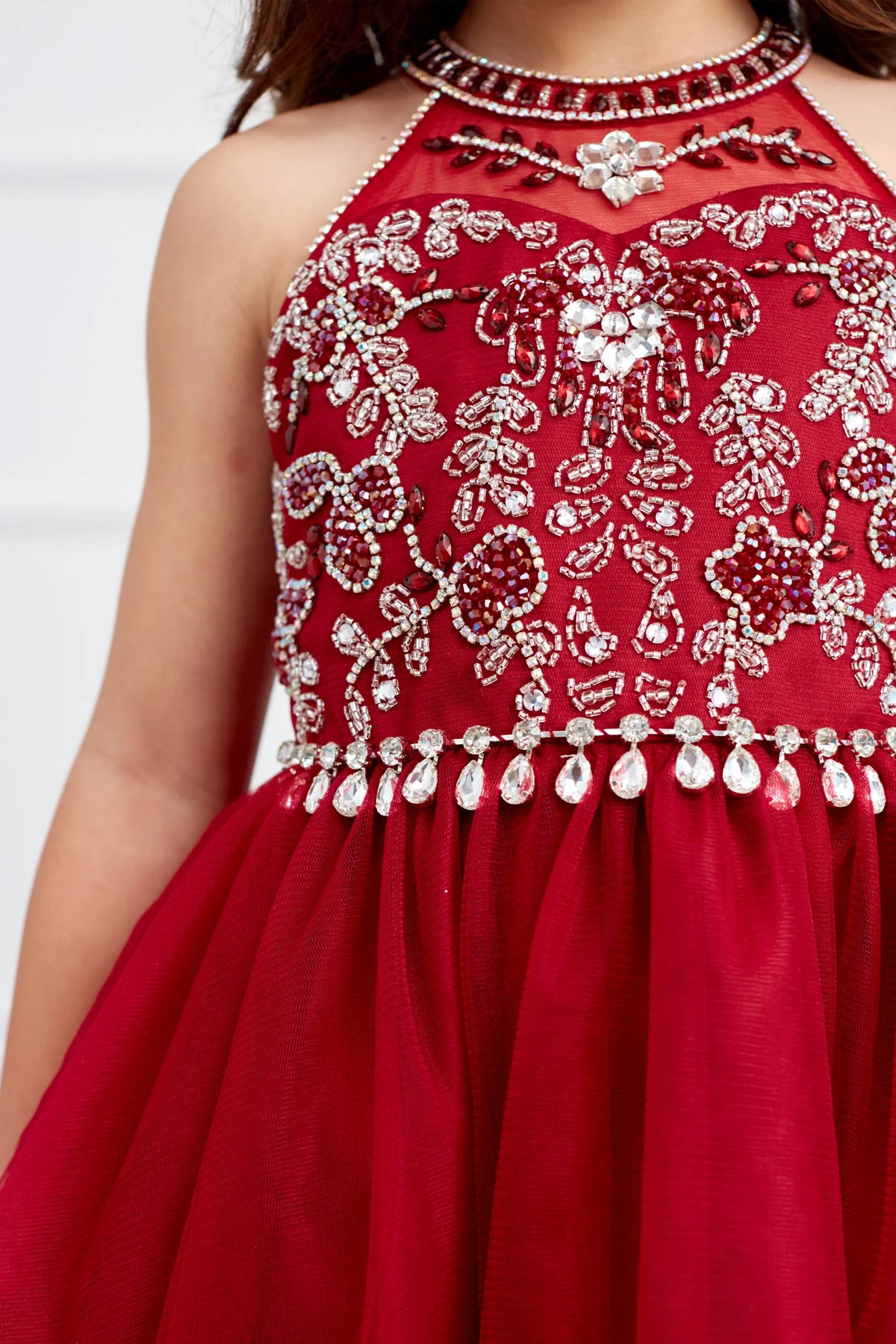 The Red kids pageant dress has dangling rhinestones along the waist.