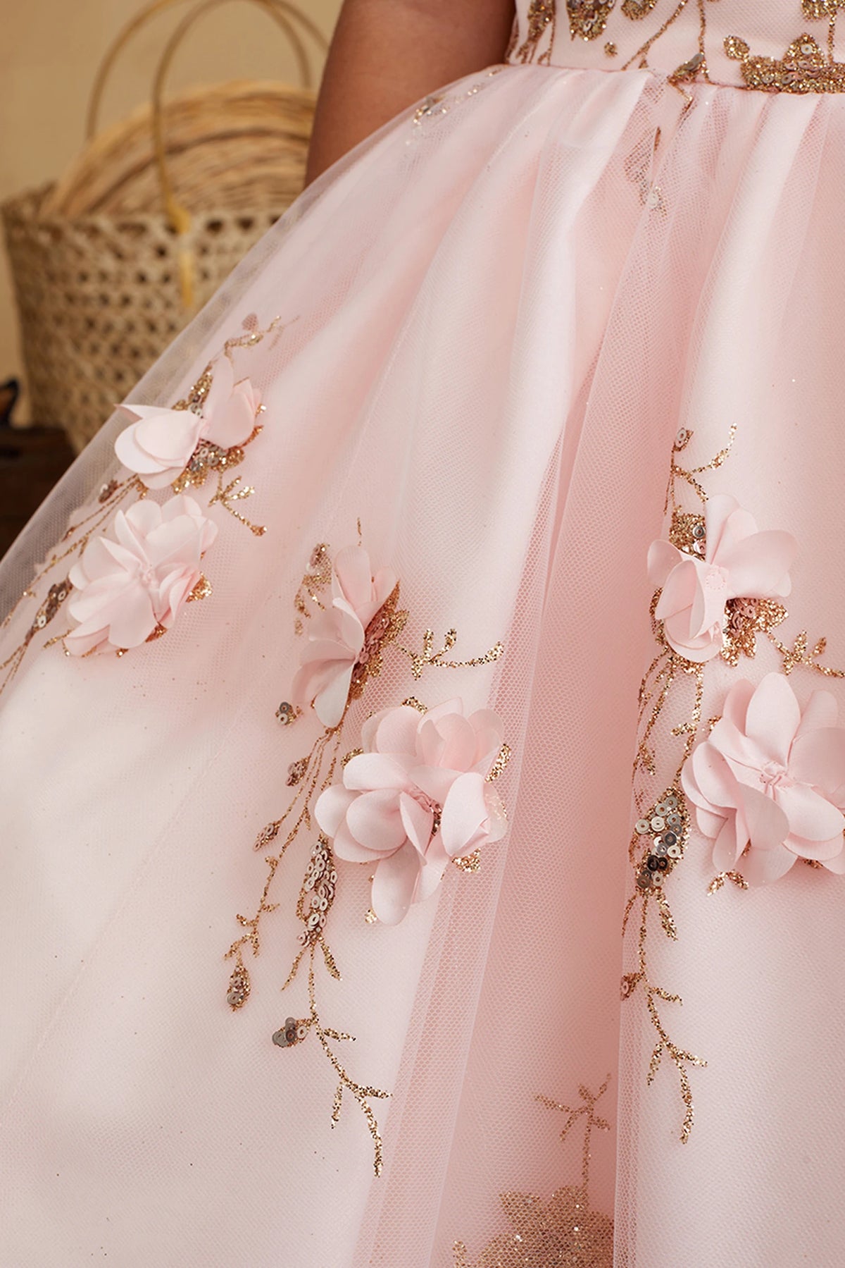 The Blush kids pageant dress has dimensional flowers on the tulle skirt.