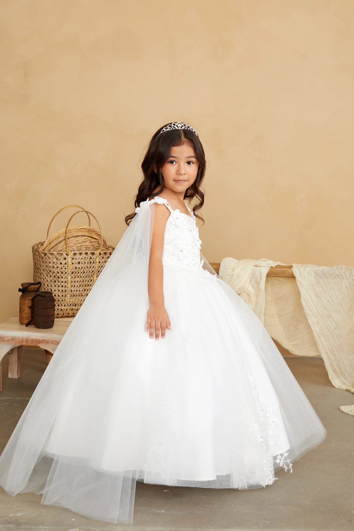 Visible details on the Ivory kids pageant dress include floral appliques on a full tulle skirt.
