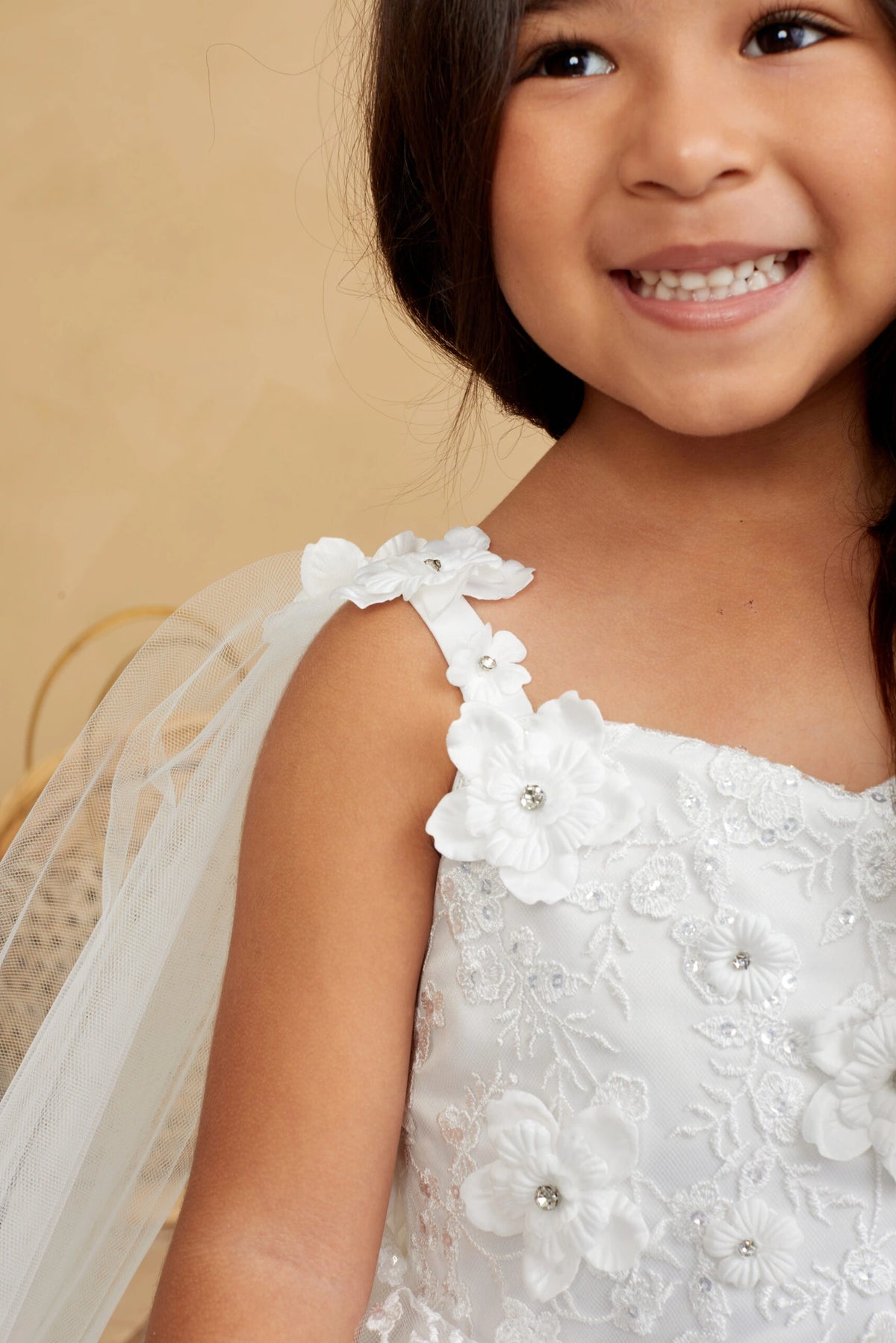 Another view of the Ivory kids pageant dress shows flower details on the upper bodice.