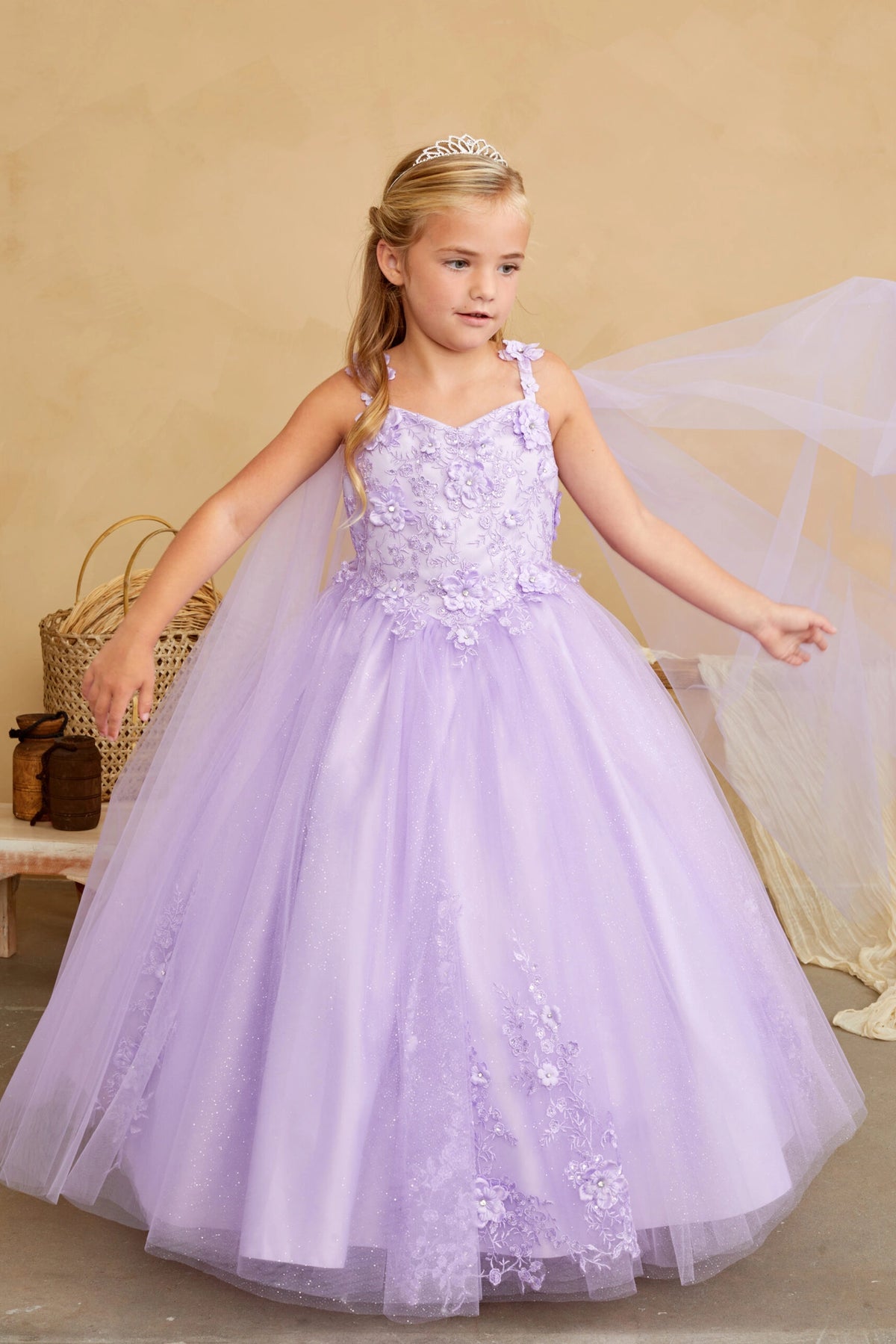 The Lilac kids pageant dress has floral appliques on a full tulle skirt.