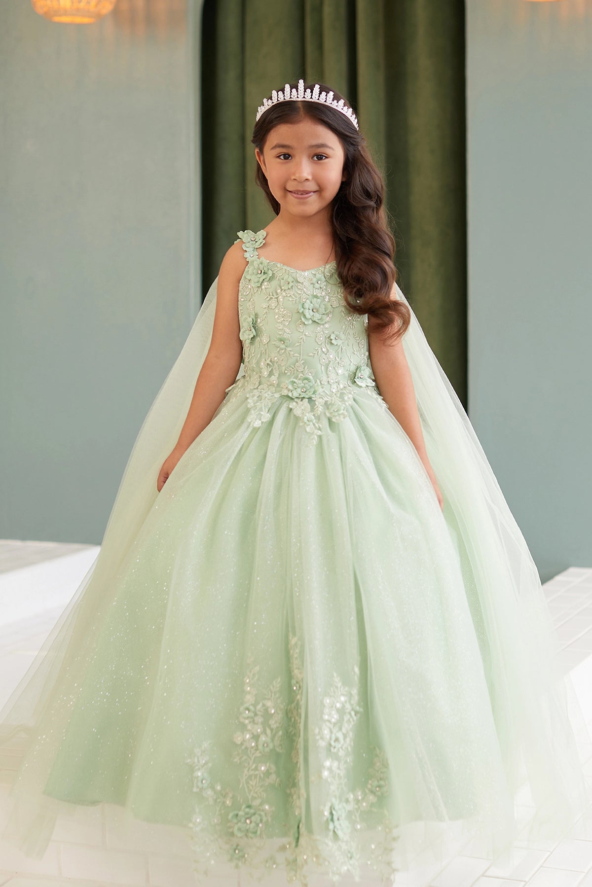 The Sage kids pageant dress has floral appliques on a full tulle skirt.