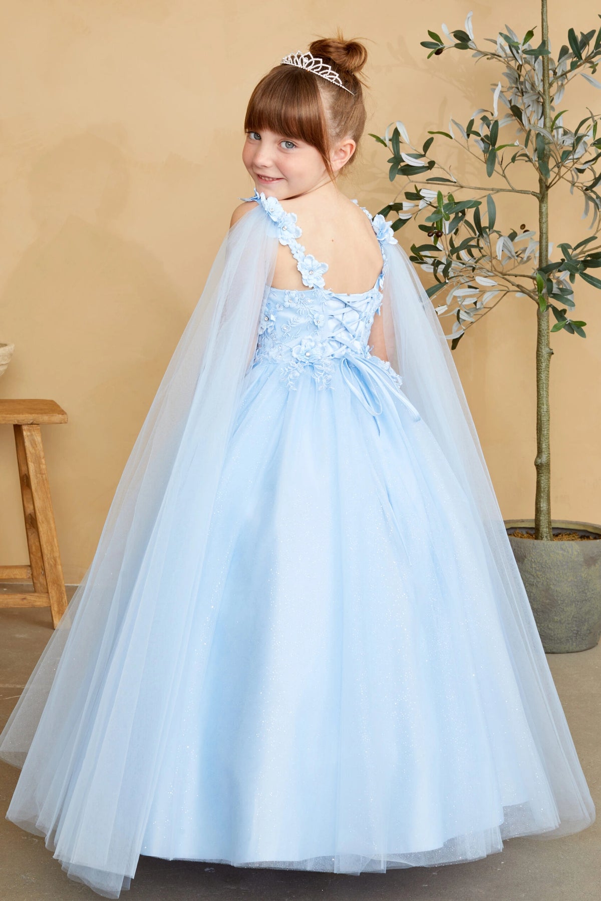The Sky Blue kids pageant dress has a tied sash across the back waist.