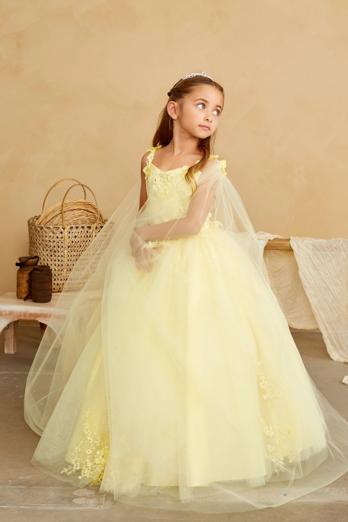 The Yellow kids pageant dress has floral appliques on a full tulle skirt.
