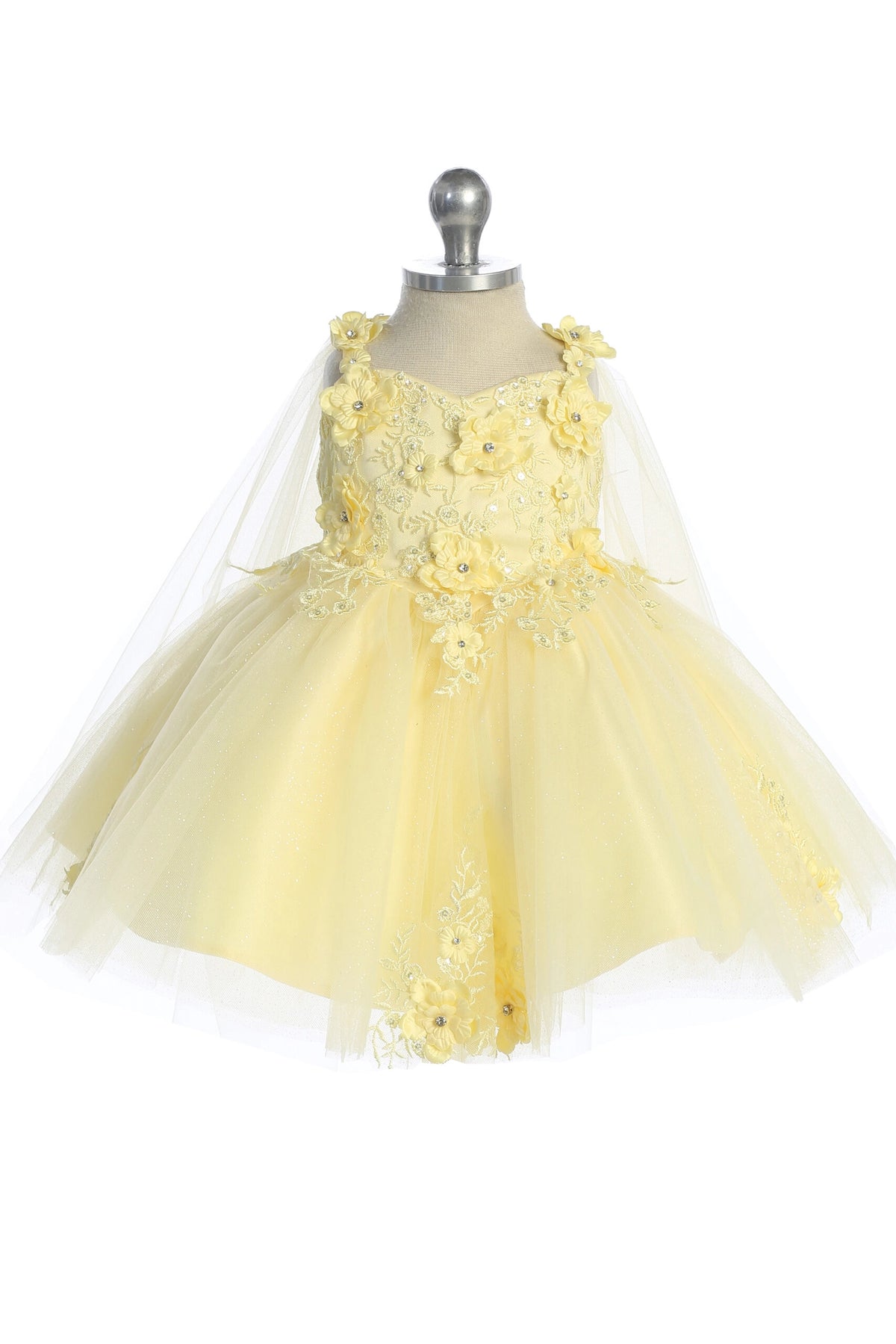 Seen from the front, this Yellow kids pageant dress displays floral appliques on a full tulle skirt.