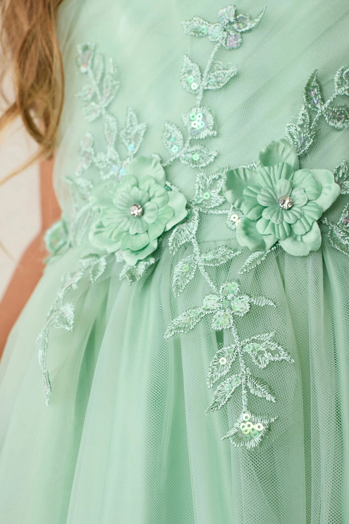 Visible details on the Sage kids pageant dress include lace appliques down the skirt.