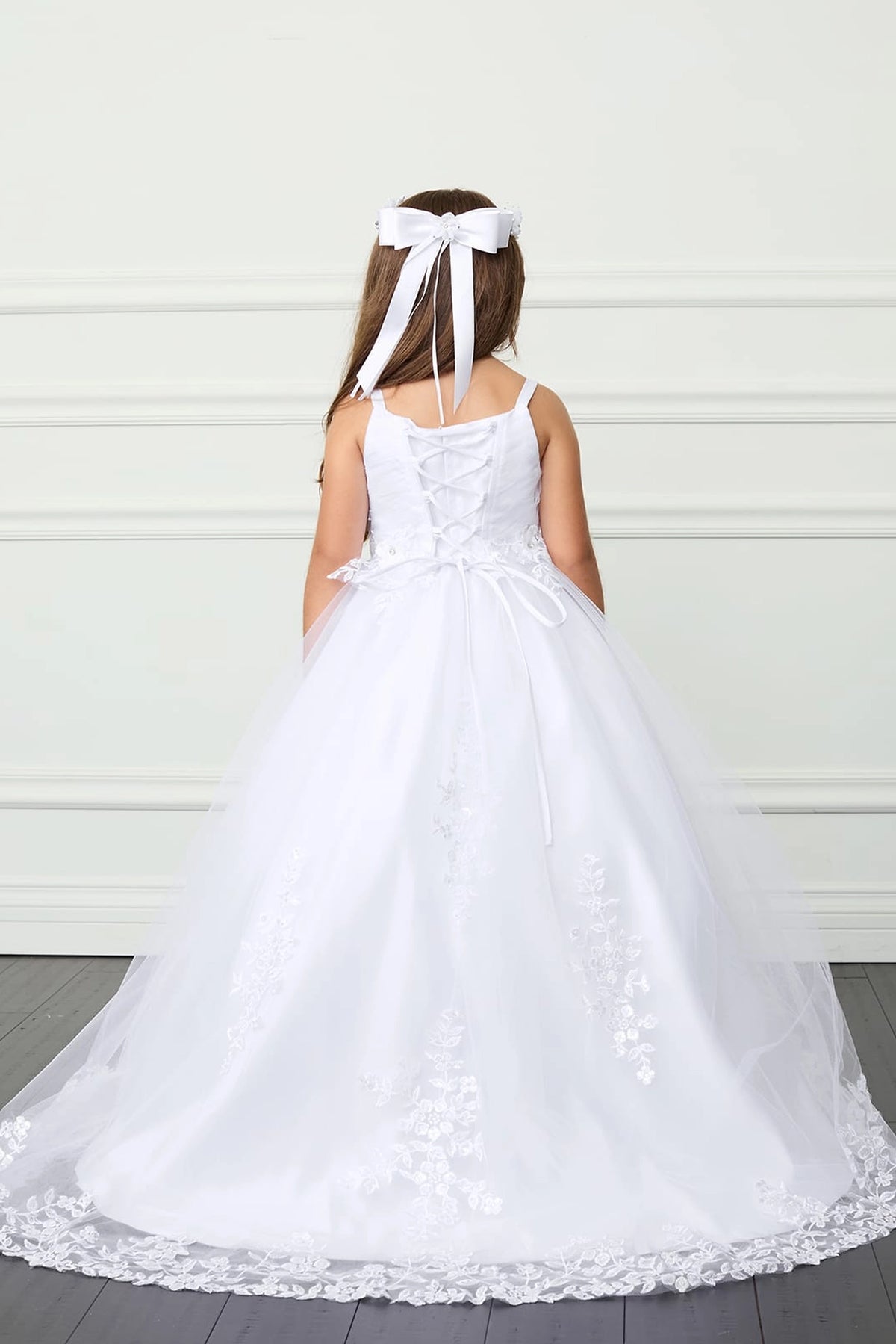 The White kids pageant dress has lace-up ties at the back.