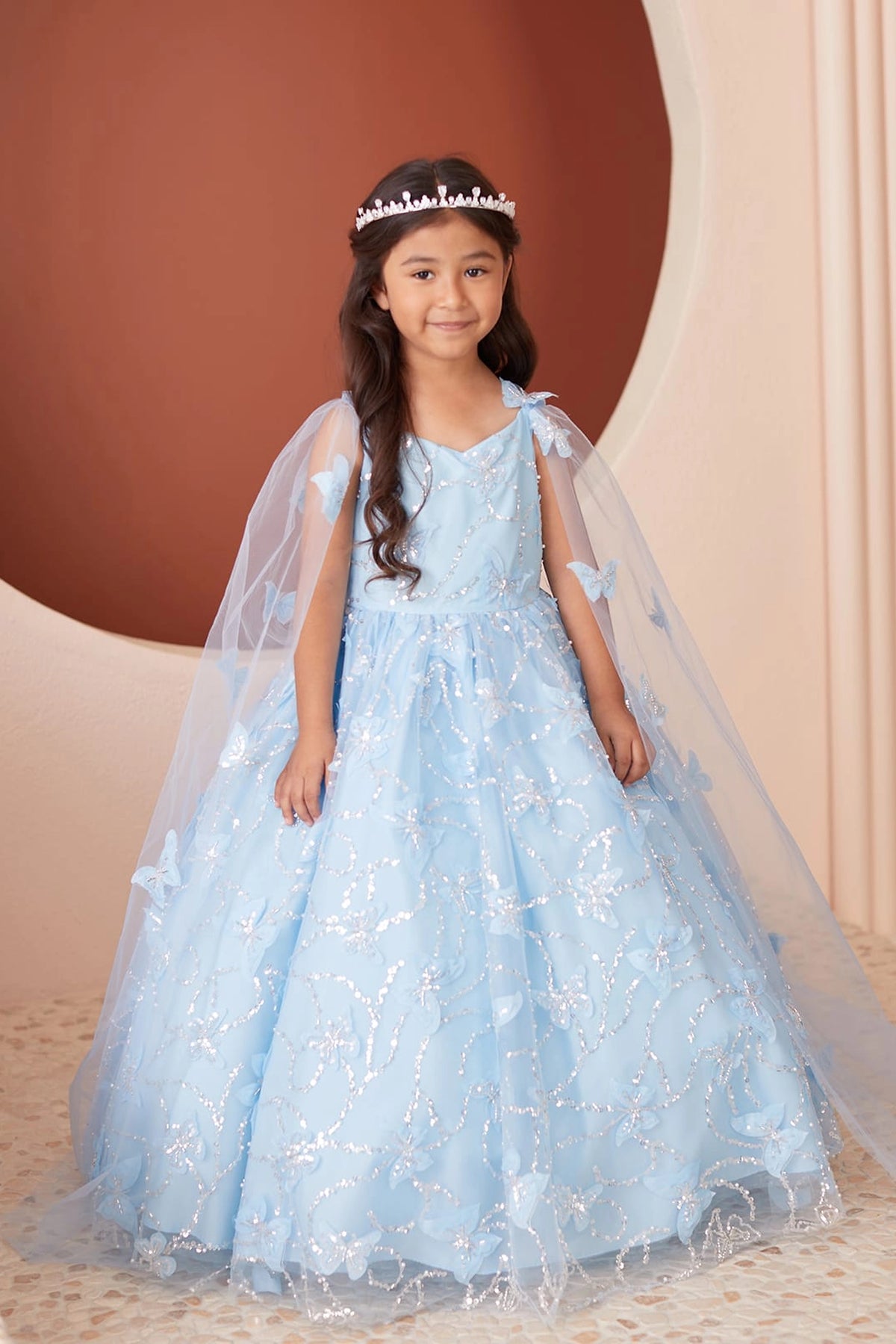 The Sky Blue kids pageant dress has raised butterfly details.