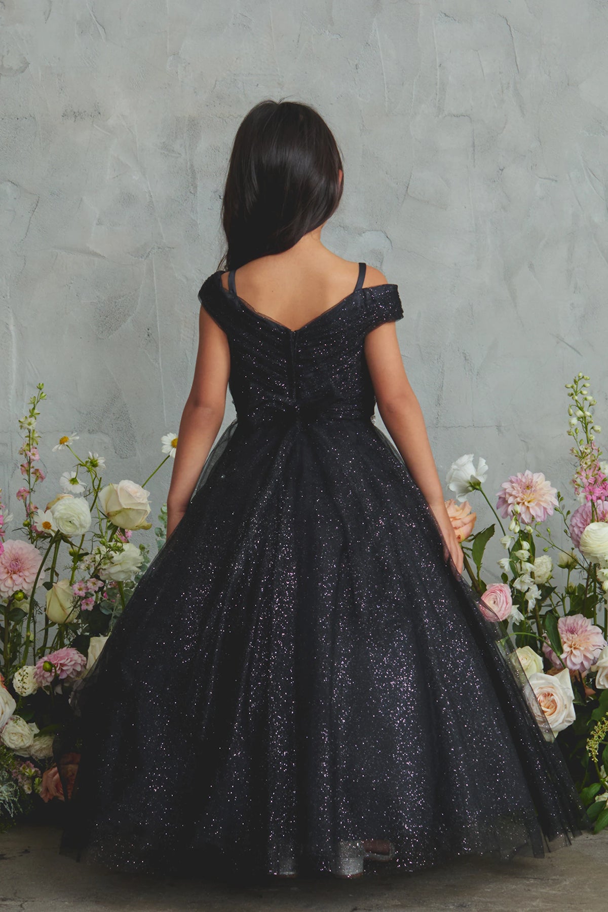 Black kids pageant dress featuring a tied sash across the back waist.