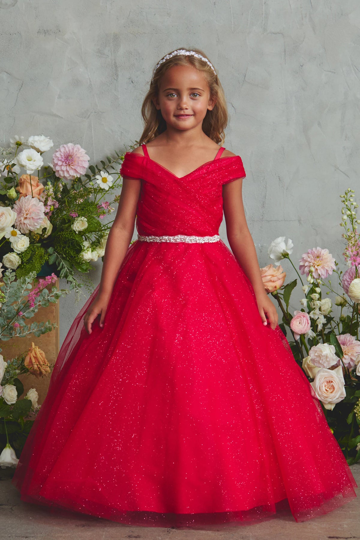 The Red kids pageant dress has an asymmetrically pleated neckline.