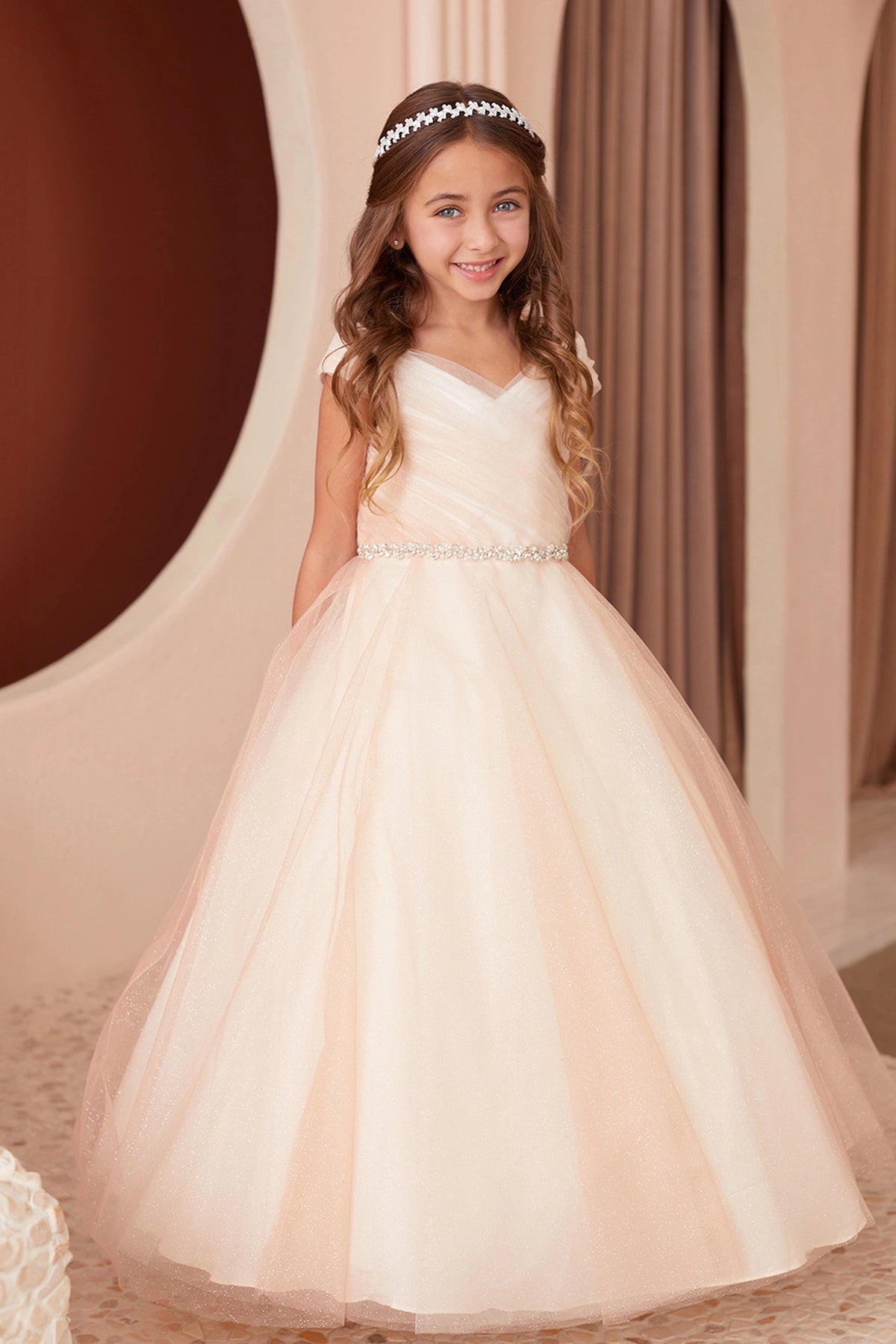Rose Gold kids pageant dress featuring an asymmetrically pleated neckline.