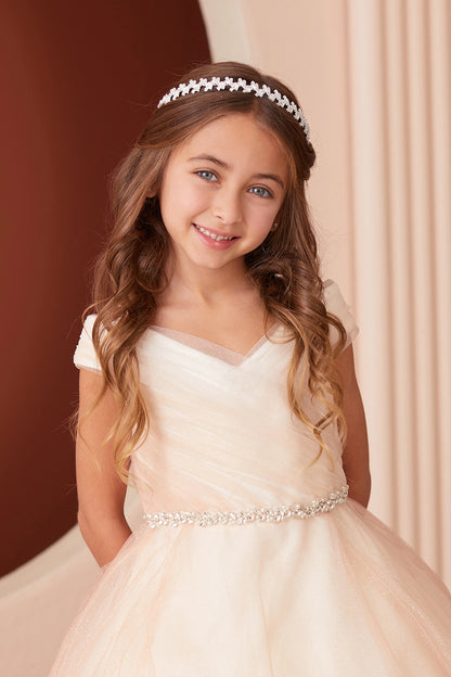 Seen from up close, this Rose Gold kids pageant dress displays asymmetric pleats at the neckline.
