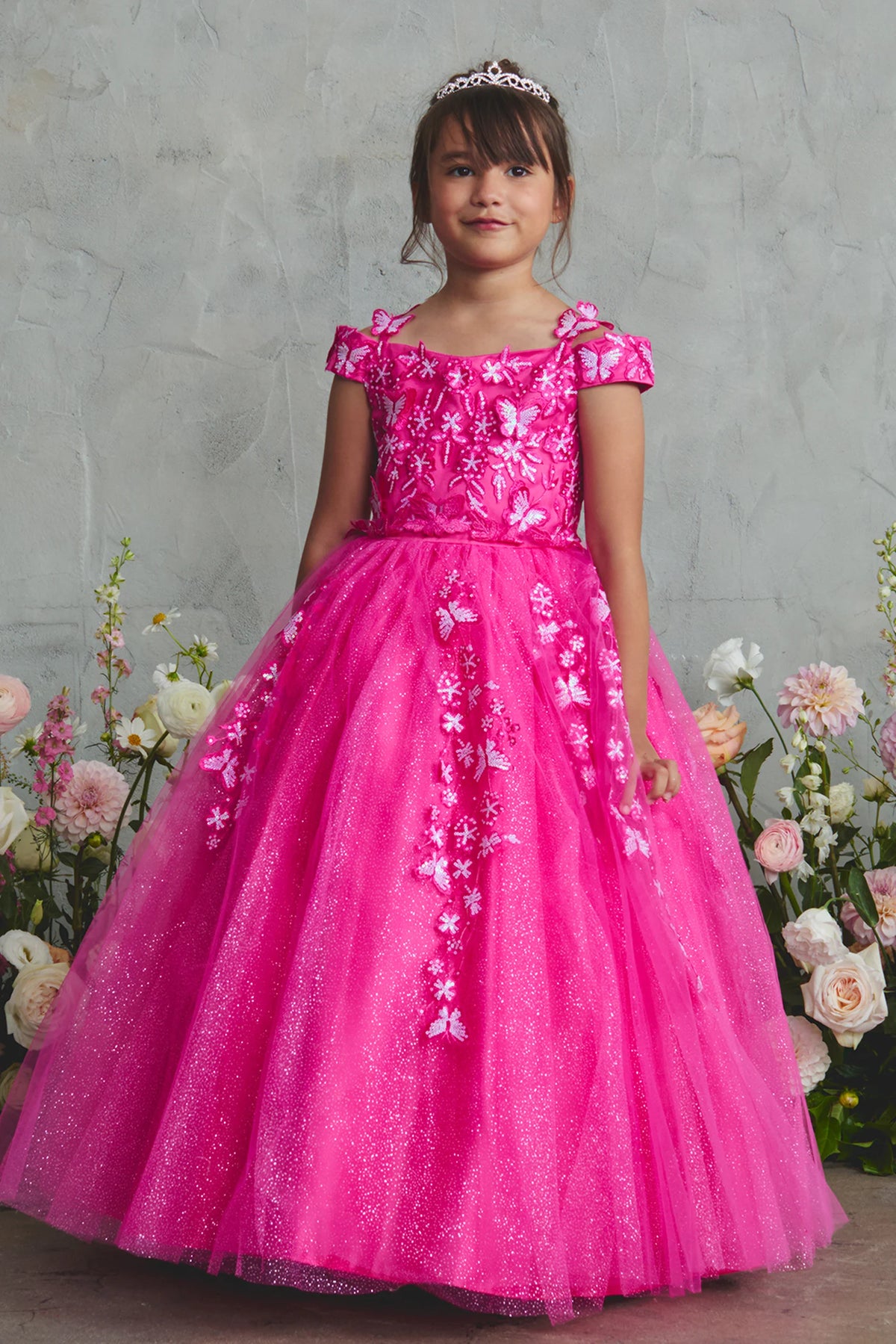 Fuchsia kids pageant dress featuring floral lace and butterfly accents.