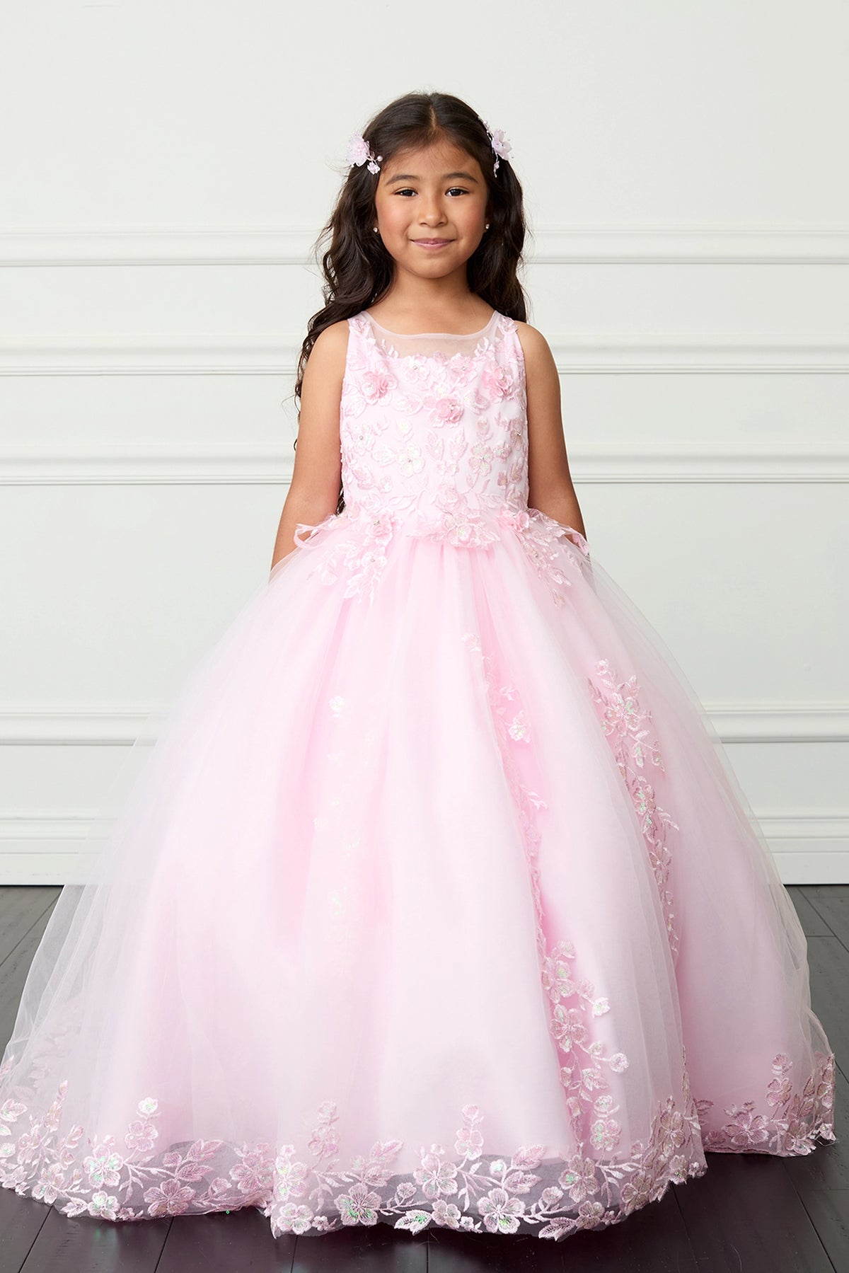 Pink kids pageant dress featuring lace appliques across the bodice and skirt.