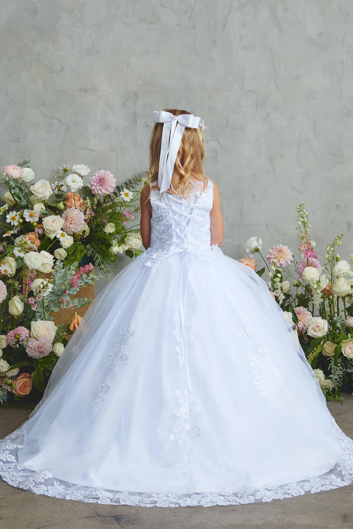 The White kids pageant dress has lace-up ties at the back.